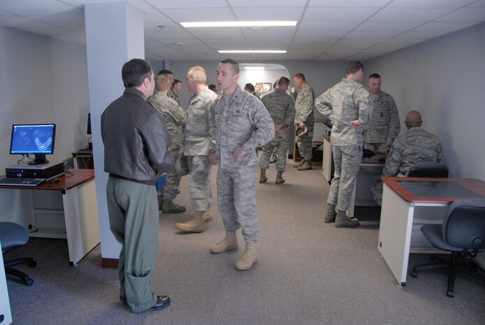 Team Charleston Airmen mingle during the grand opening of the Dispersed Airmen?s Center on base Dec. 23. The Airmen Ministry Center/Internet Caf? was the first of four separate sections to open for the center. (.U.S. Air Force photo/Airman 1st Class Melissa White)