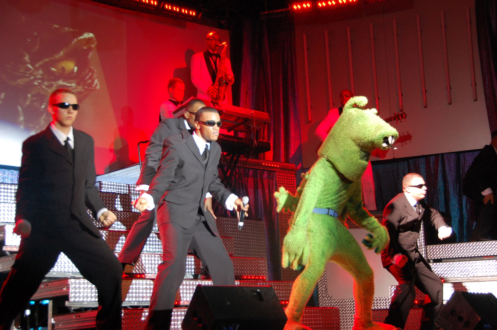 Members of Tops In Blue perform the song "Men In Black" during their performance Dec. 21 at Osan Air Base, South Korea. Tops In Blue is the premier entertainment group for the U.S. Air Force. They are currently touring the world on their "Deja Blue" tour. (U.S. Air Force photo/Staff Sgt. Lakisha Croley) 
