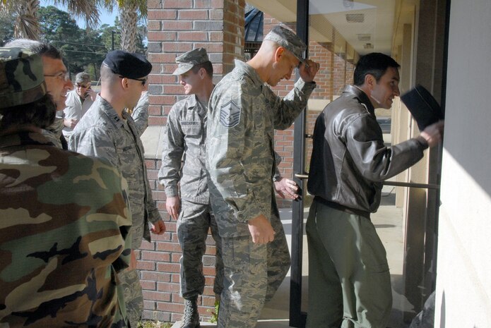 Team Charleston Airmen enter the Airmen Ministry Center/Internet Caf? during the grand opening of the Dispersed Airmen?s Center on base Dec. 23. The Airmen Ministry Center/Internet Caf? was the first of four separate sections to open for the center. (U.S. Air Force photo/Airman 1st Class Melissa White)