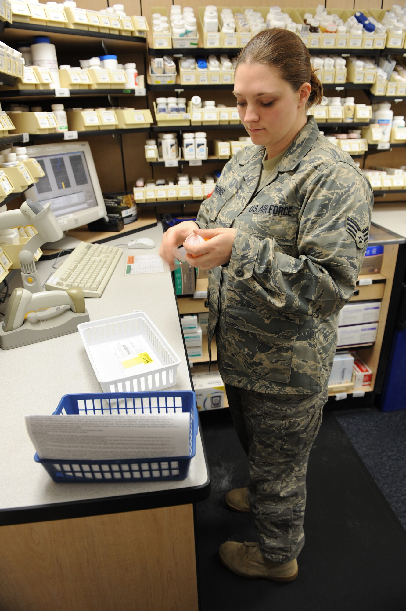 WHITEMAN AIR FORCE BASE, Mo. - Senior Airman Vera Pickering, 509th Medical Group pharmacy technician, labels prescription bottles Dec. 16. Airman Pickering ensures the correct labels and directions are put on each bottle, allowing the patient to know when and how much of their medication to take. (U.S.  Air Force photo/Airman 1st Class Carlin Leslie)
