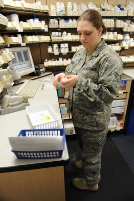 WHITEMAN AIR FORCE BASE, Mo. - Senior Airman Vera Pickering, 509th Medical Group pharmacy technician, labels prescription bottles Dec. 16. Airman Pickering ensures the correct labels and directions are put on each bottle, allowing the patient to know when and how much of their medication to take. (U.S.  Air Force photo/Airman 1st Class Carlin Leslie)
