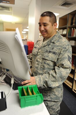 WHITEMAN AIR FORCE BASE, Mo. - Staff Sgt. David Mendez, 509th Medical Group pharmacy technician, logs in an order Dec. 16 for a prescription at the Whiteman Pharmacy front window. The pharmacyfront window is the first place patients go to get their prescriptions filled then it will travel through a precise production line monitored by computers and technicians to ensure the correct medication are given. (U.S.  Air Force photo/Airman 1st Class Carlin Leslie)