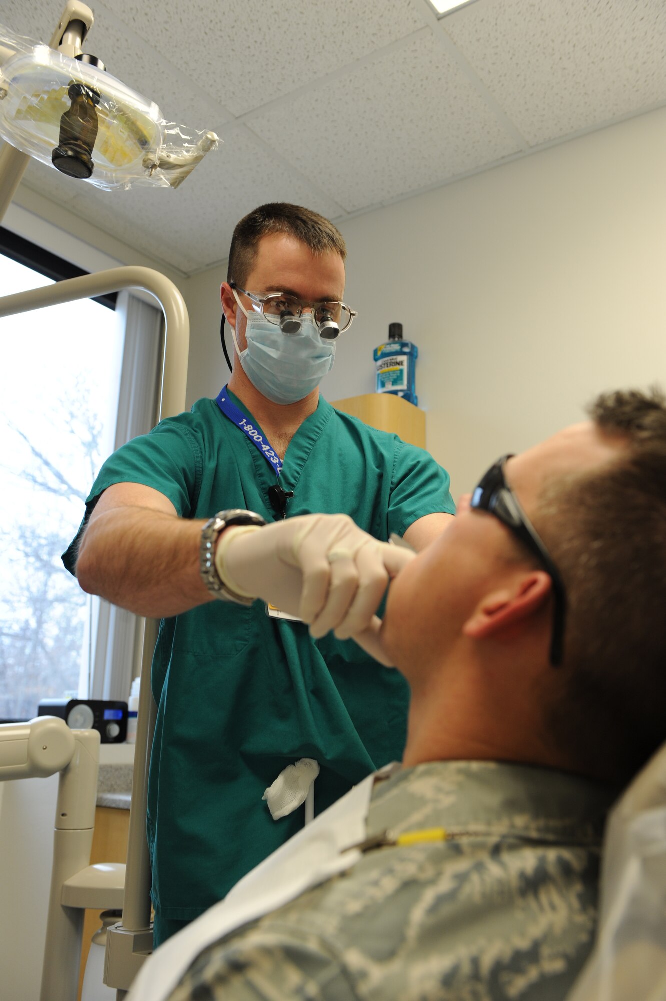 WHITEMAN AIR FORCE BASE, Mo. - Capt. Carl Bhend, 509th Medical Group dental clinic dentist, inserts molding paste into a patient?s mouth Dec. 15 during a training session. Captain Bhend inserts the paste by hand into the mouth before inserting the whole plate to ensure all gaps are filled to provide an accurate molding of the lower teeth. (U.S.  Air Force photo/Airman 1st Class Carlin Leslie)