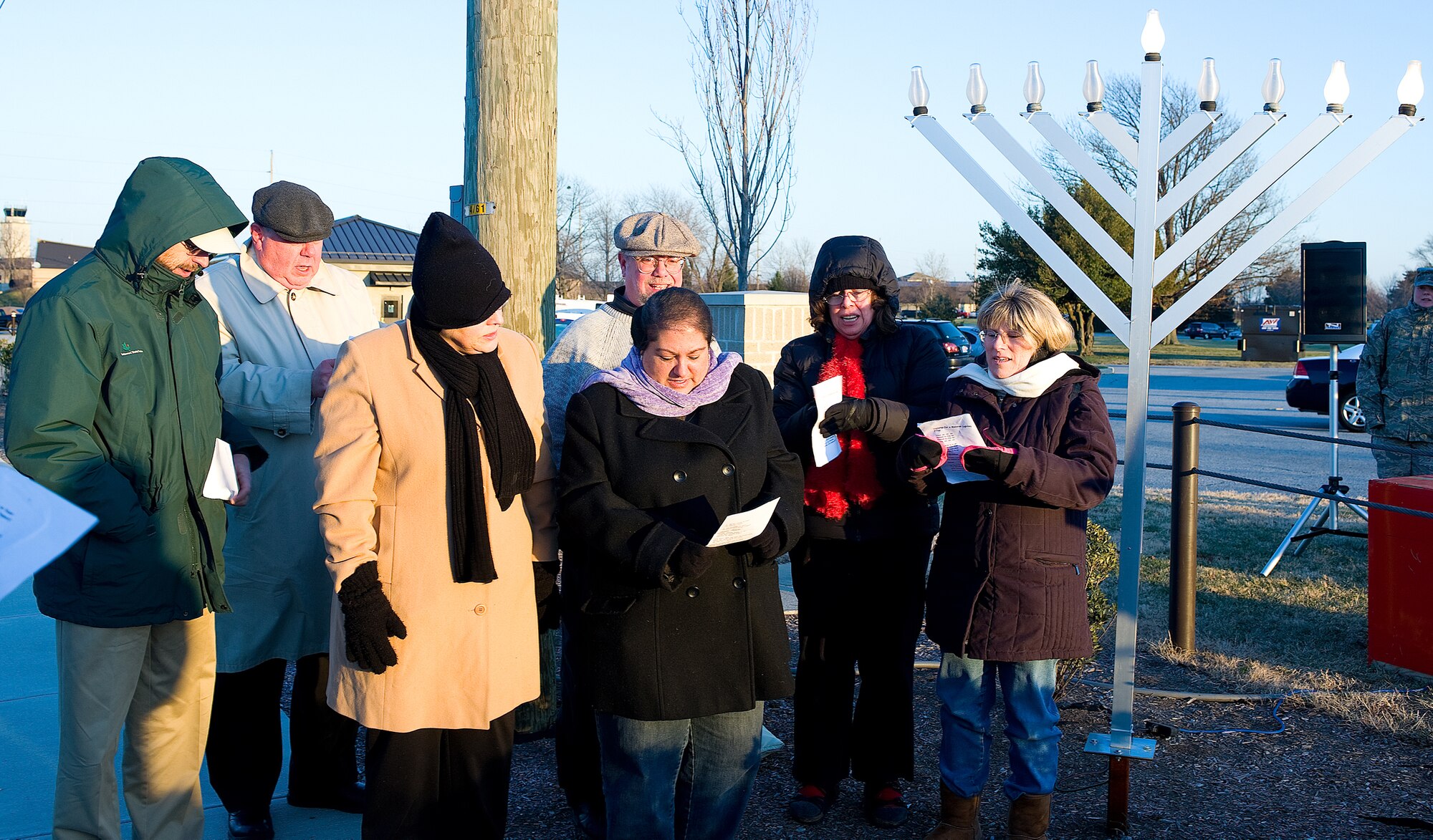 Attendees sing songs during the menorah lighting ceremony here Dec. 22.  (U.S. Air Force photo/Roland Balik)