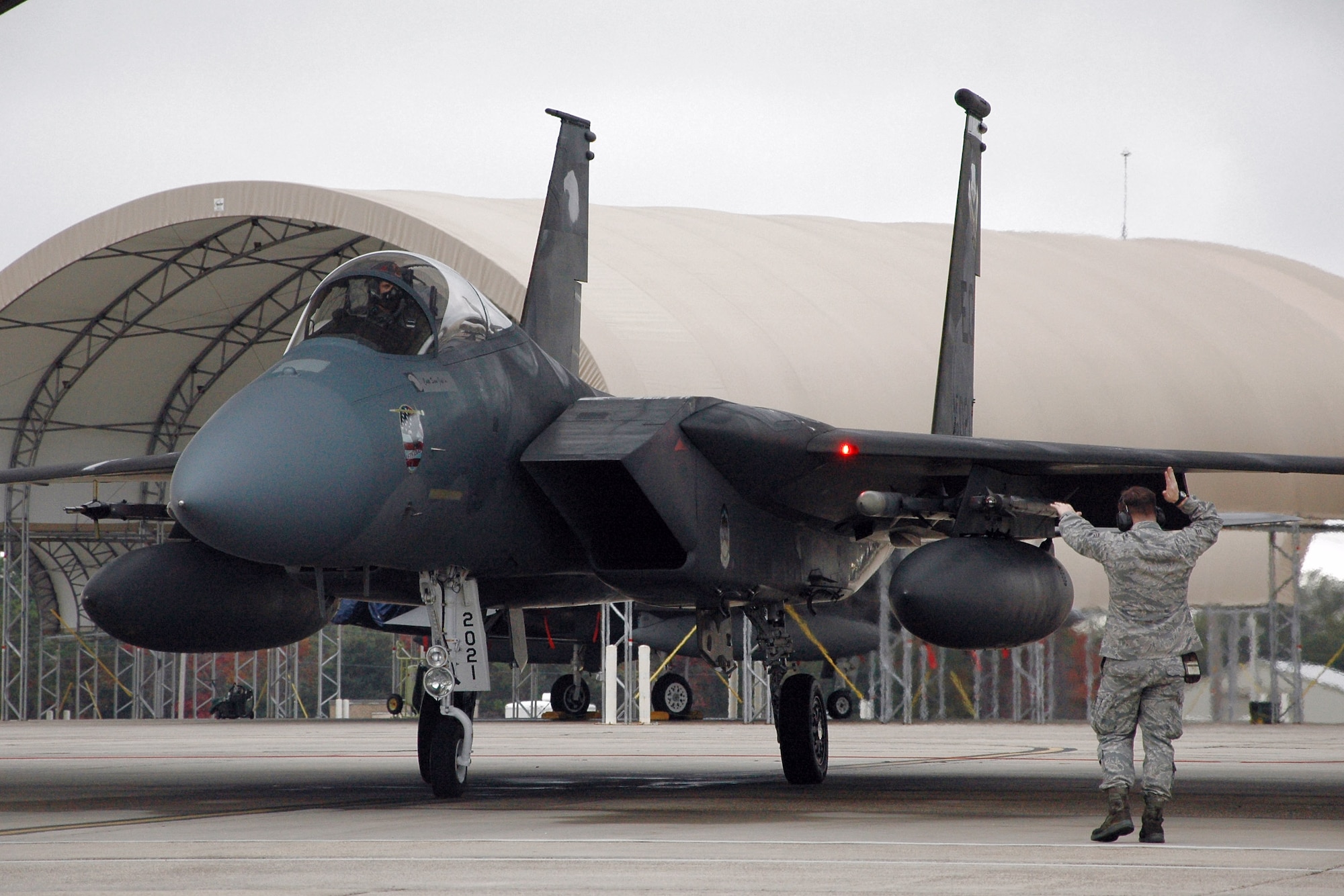 A 58th Aircraft Maintenance Unit crew chief marshals an F-15 Eagle ready to takeoff for a simulated Operation Noble Eagle tasking during a 33rd Fighter Wing exercise Dec. 17 at Eglin Air Force Base, Fla. (U.S. Air Force photo/Chrissy Cuttita) 

