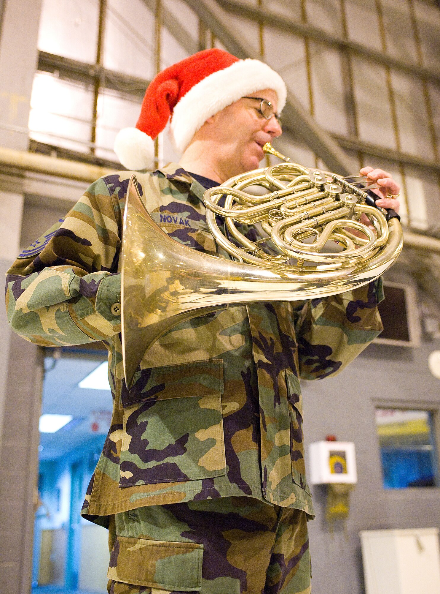Master Sgt. Roger Novak, U.S. Air Force Heritage of America 'Langley Winds' band member, performs for Dover Airmen Dec. 16. The U.S. Air Force Heritage of America Band 'Langley Winds' is a five-member active duty group with a long history of entertaining the American public and promoting esprit de corps within the military.  Consisting of several unique musical ensembles, the USAF Heritage of America Band performs for more than one million people throughout a six-state region from Pennsylvania to South Carolina each year.  (U.S. Air Force photo/Thomas Randle)   