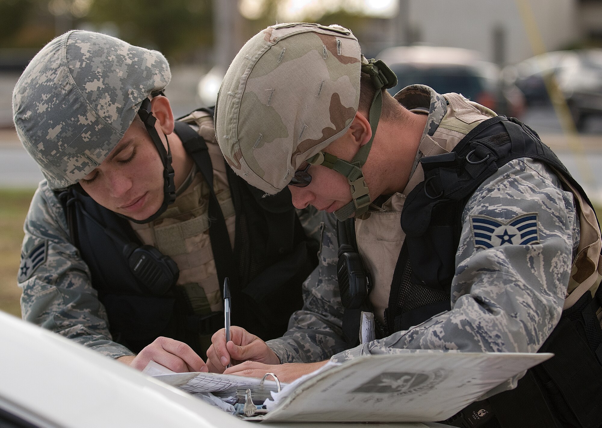 (Left)Senior Airman Gerald Murphy and Staff Sgt. Charles Edwards, 436th Security Forces Squadron, confer on how to respond to an exercise incident near Bldg. 600 during the Major Accident Response Exercise Oct. 29.  (U.S. Air Force photo/Roland Balik)