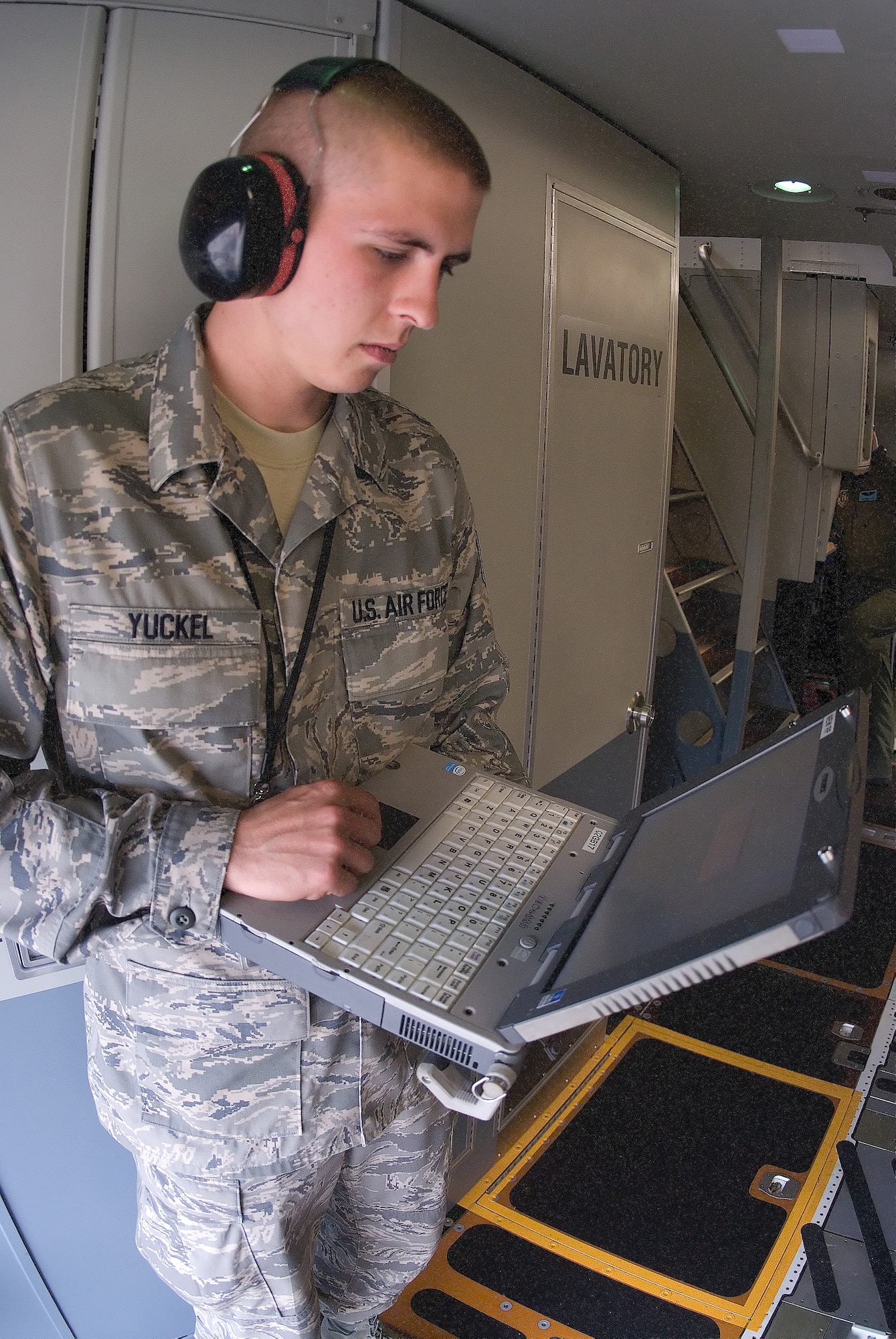 Staff Sergeant Eric Yuckel, 736th Aircraft Maintenance Squadron, uses a laptop computer to access C-17 aircraft technical orders.