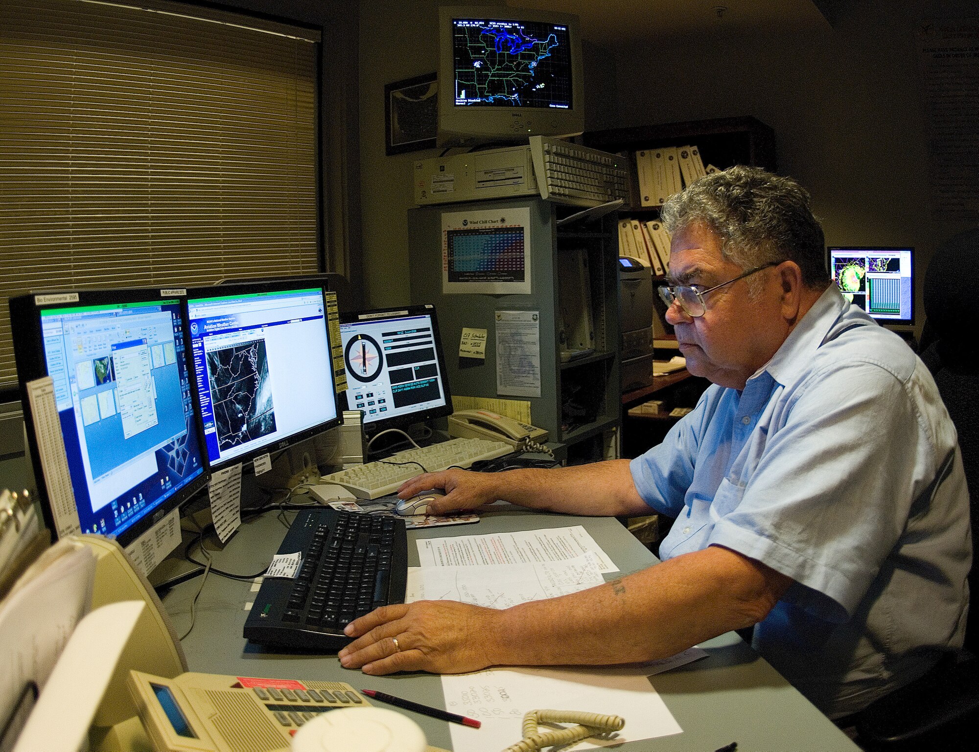 Carl Colvin, a weather forecaster assigned to the 436th Operations Support Squadron's Weather Flight, searches for the latest weather information.