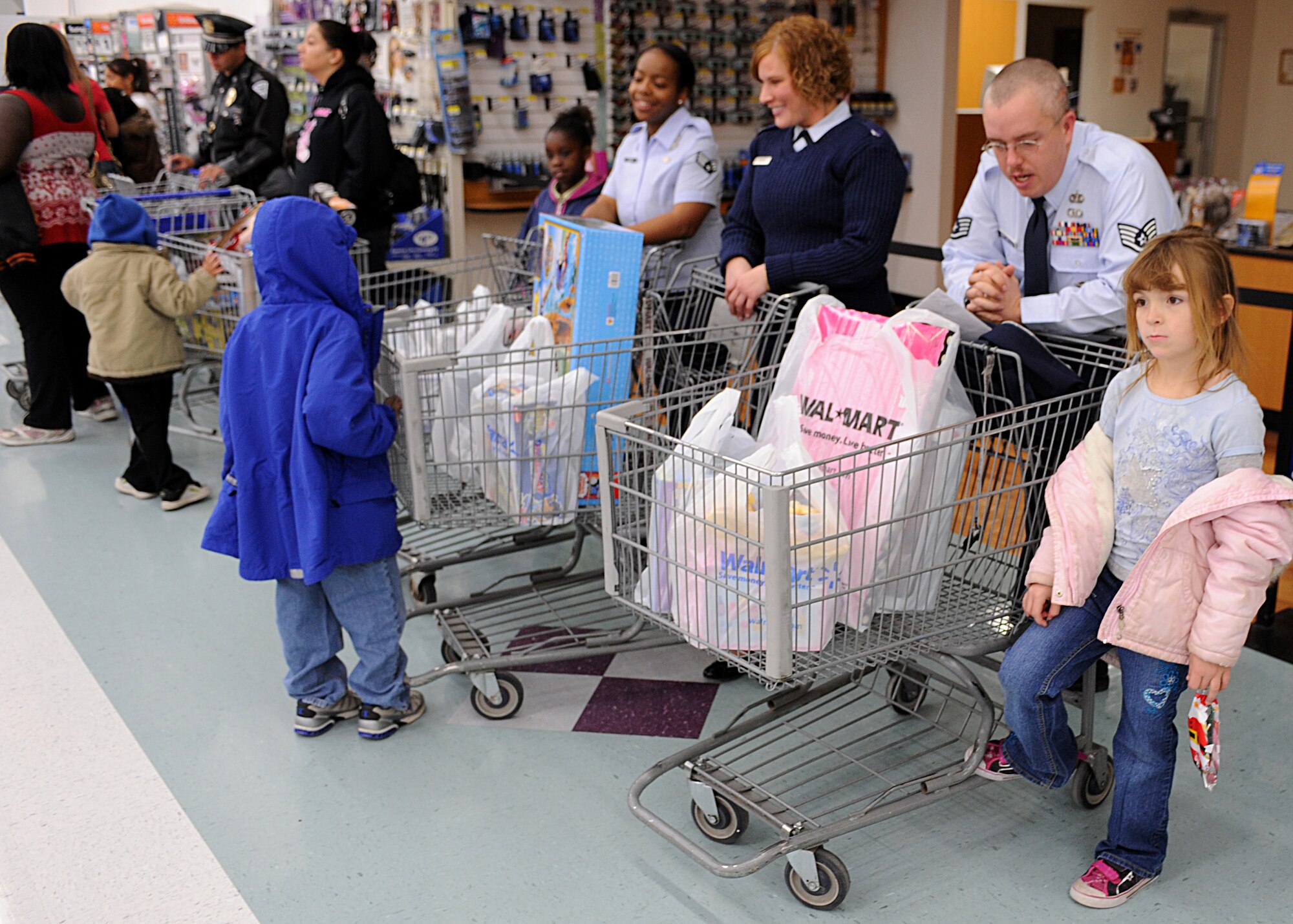 CANNON AIR FORCE BASE, N.M. -- 27th Special Operations Security Forces Airmen joined with Clovis police officers during the Shop with a Cop program, Dec. 22. The annual program teams local police and Cannon security forces Airmen to help children spend a donated $100 gift card. (U.S. Air Force photo/Airman 1st Class Evelyn Chavez)  