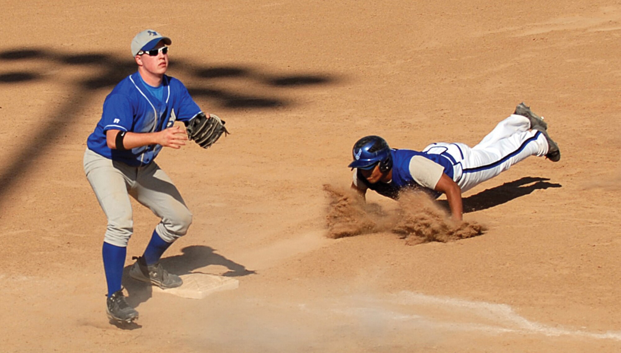 James Wright, Luke Falcons starting outfielder, dives for third during the 2008 Air Force Varsity Baseball Bash held at Millennium High School Sept. 25. The Falcons dominated the competition winning every game and taking championship for the second year in a row. (U.S. Air Force photo/Airman 1st Class C.J. Hatch)