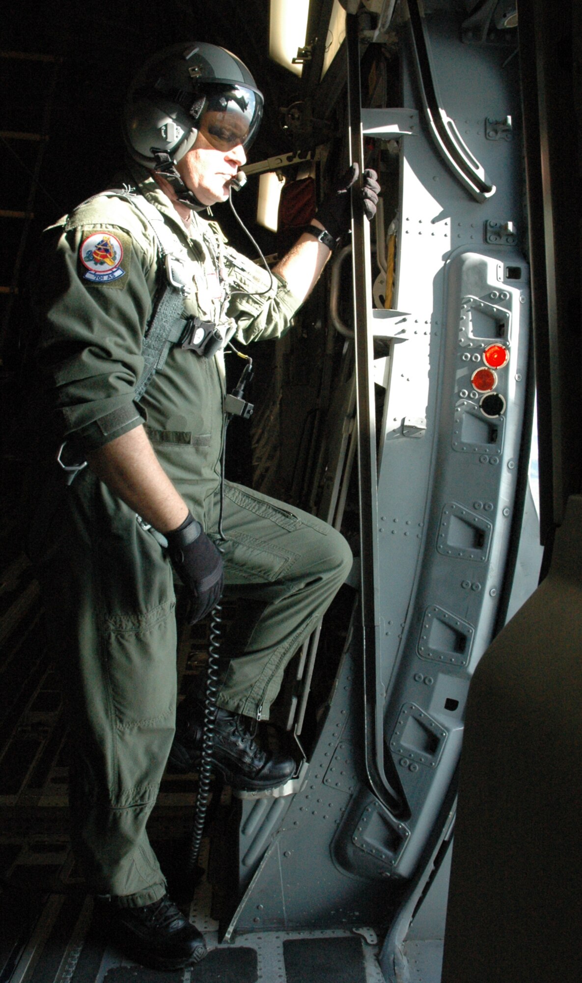 Master Sergeant Tim Schnaible, a loadmaster with the 317th Airlift Squadron, prepares for a simulated personnel drop during the 13 aircraft formation performed as part of a training mission on Dec 18.
