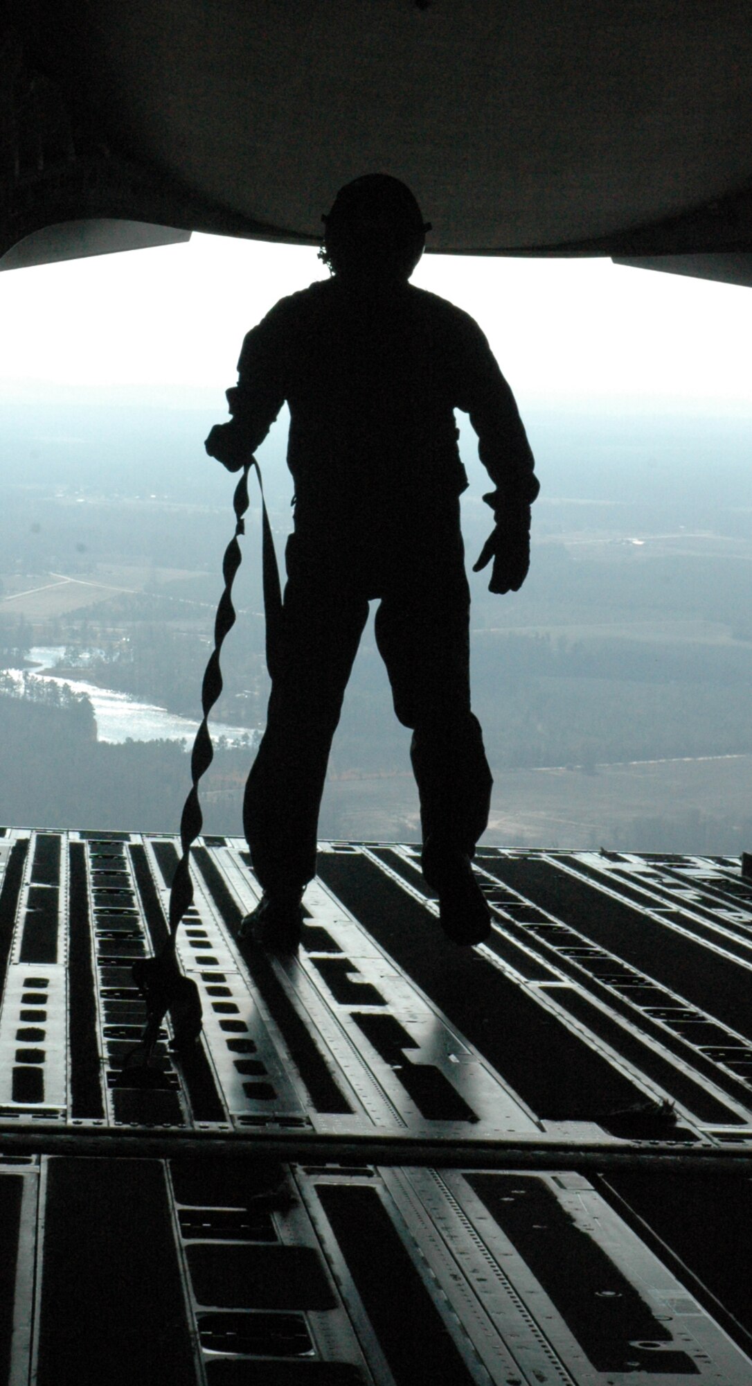 Master Sergeant Tim Schnaible, a loadmaster with the 317th Airlift Squadron, prepares for a simulated cargo air drop over North Auxiliary Field during a 13 aircraft formation performed as part of a training mission on Dec 18.