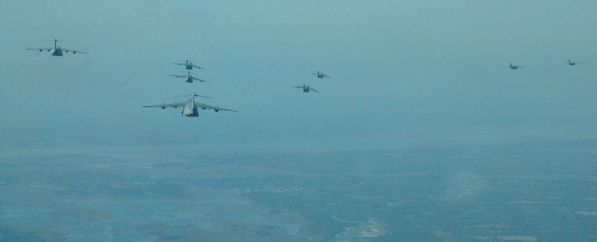 Thirteen Charleston AFB C-17’s fly over the Charleston area in route to North Auxiliary Field to perform a Container Delivery System airdrop as part of a large formation training mission on Dec. 18.