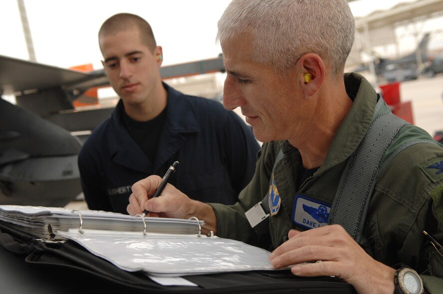 Col. David Lujan, 56th Operations Group deputy commander, fills out his flight log moments after completing his 4,000th hour in the F-16 Fighting Falcon airframe at Luke AFB, Ariz., Dec. 22.  (U.S. Air Force photo/Tech Sgt. Jeffrey A. Wolfe)