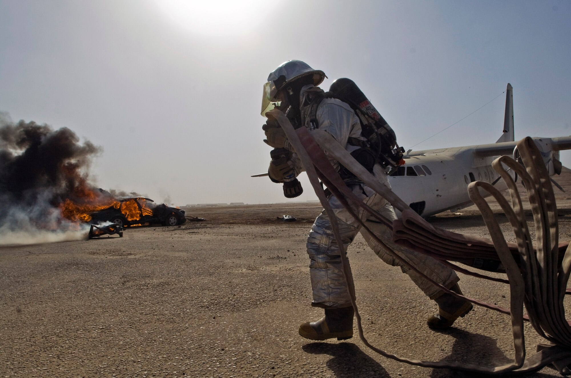 Senior Airman Bradley Richgels pulls out a fire hose in response to a vehicle fire Dec. 17 at Ali Base, Iraq. Airman Richgels and other firefighters with the 407th Expeditionary Civil Engineer Squadron held a training exercise to test how Airmen response to a vehicle fire. He is deployed from the Minnesota Air National Guard's 133rd Airlift Wing. (U.S. Air Force photo/Senior Airman Christopher Griffin) 

