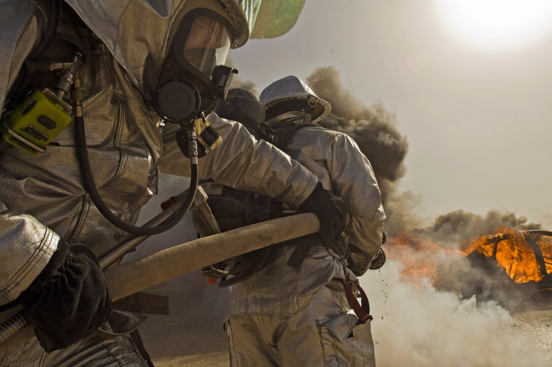 Senior Airman Bradley Richgels helps position a fire hose in response to a vehicle fire Dec. 17 at Ali Base, Iraq. Airman Richgels and other firefighters with the 407th Expeditionary Civil Engineer Squadron held a training exercise to test how Airmen response to a connex and vehicle fire. He is deployed from the Minnesota Air National Guard's 133rd Airlift Wing. (U.S. Air Force photo/Senior Airman Christopher Griffin) 
