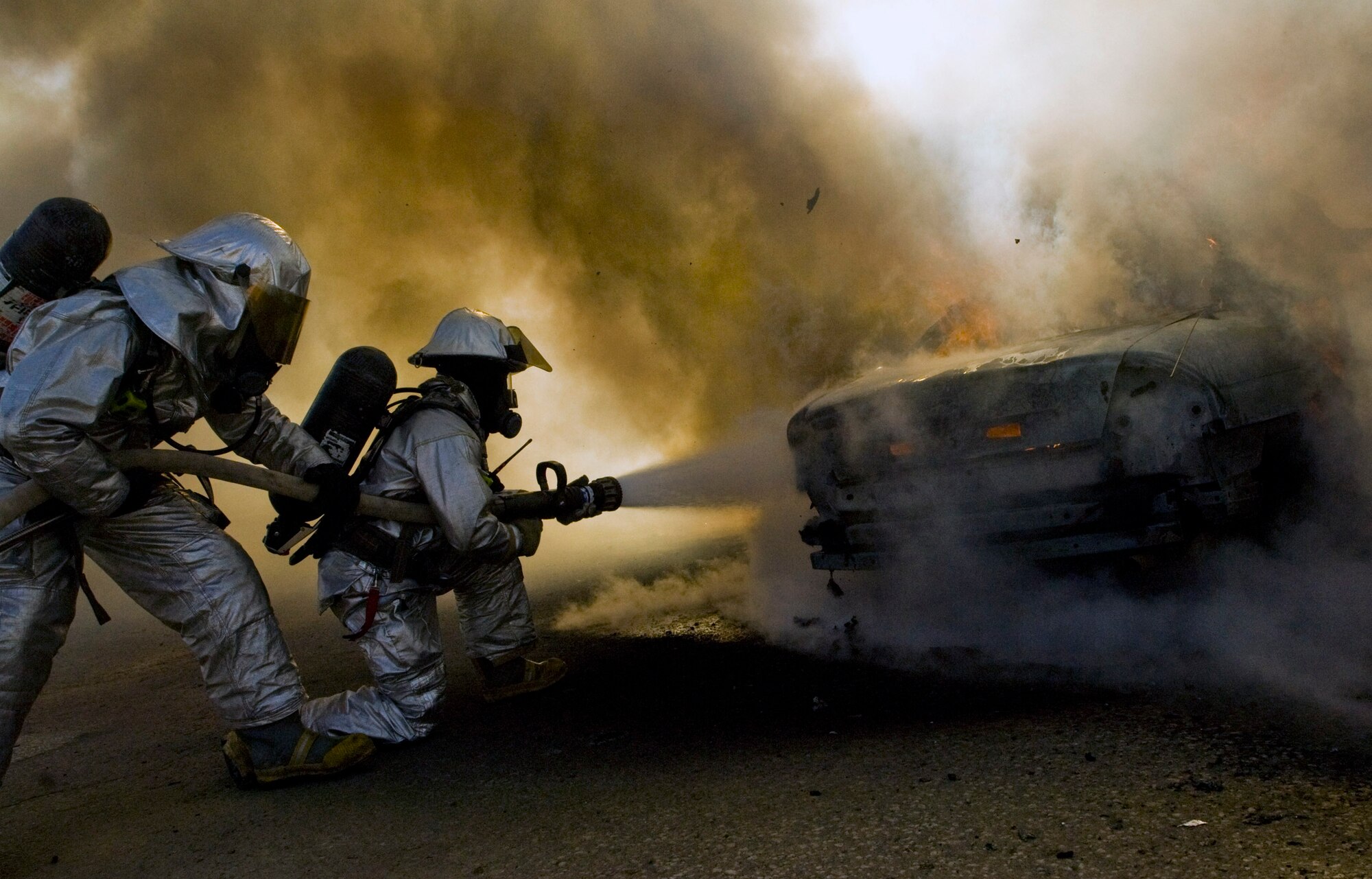 Firefighters with the 407th Expeditionary Civil Engineer Squadron practice their response to a vehicle fire during an exercise Dec. 17 at Ali Base, Iraq. (U.S. Air Force photo/Senior Airman Christopher Griffin) 
