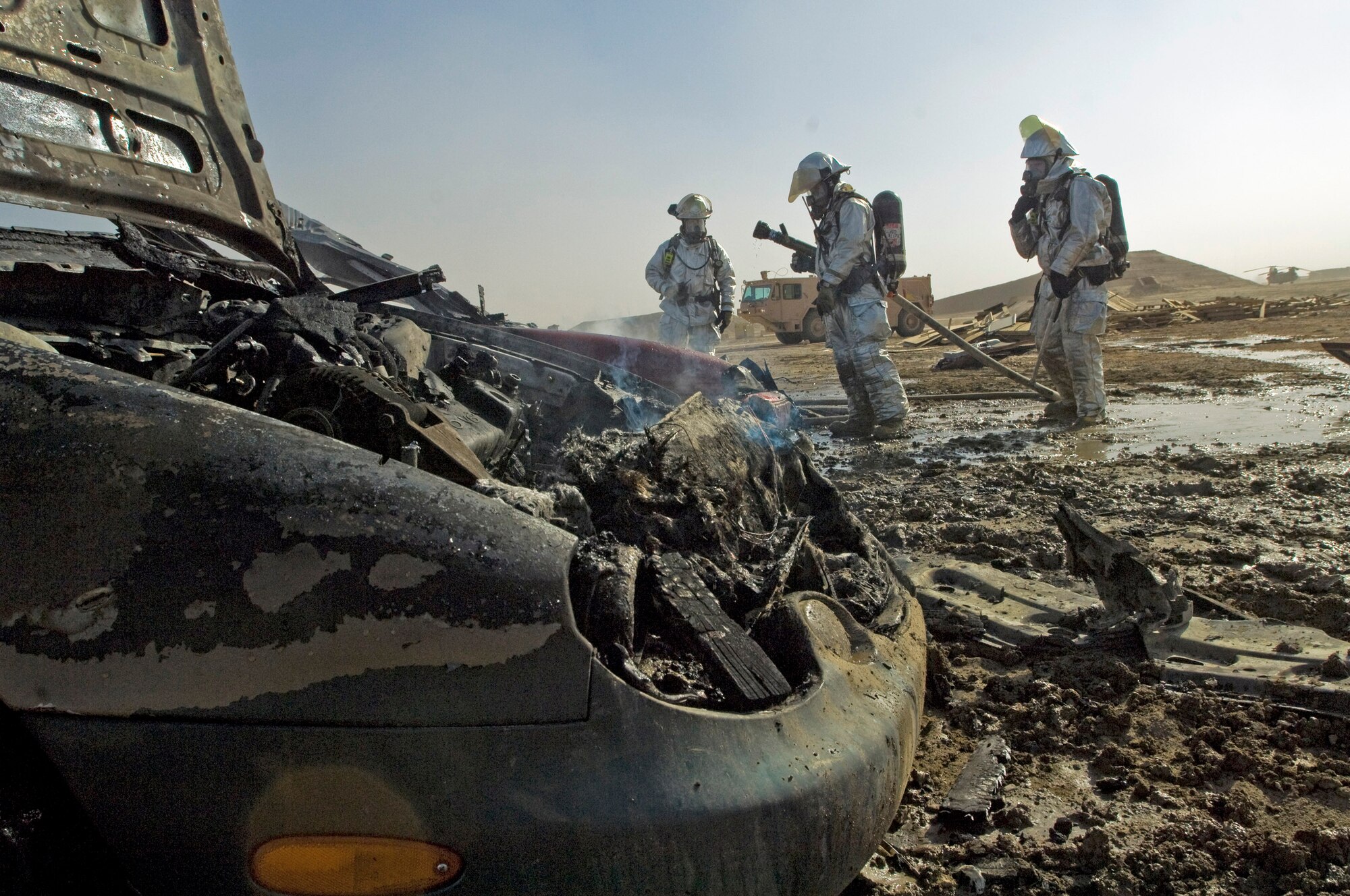 Firefighters with the 407th Expeditionary Civil Engineer Squadron practice their response to a vehicle fire during an exercise Dec. 17 at Ali Base, Iraq. (U.S. Air Force photo/Senior Airman Christopher Griffin) 
