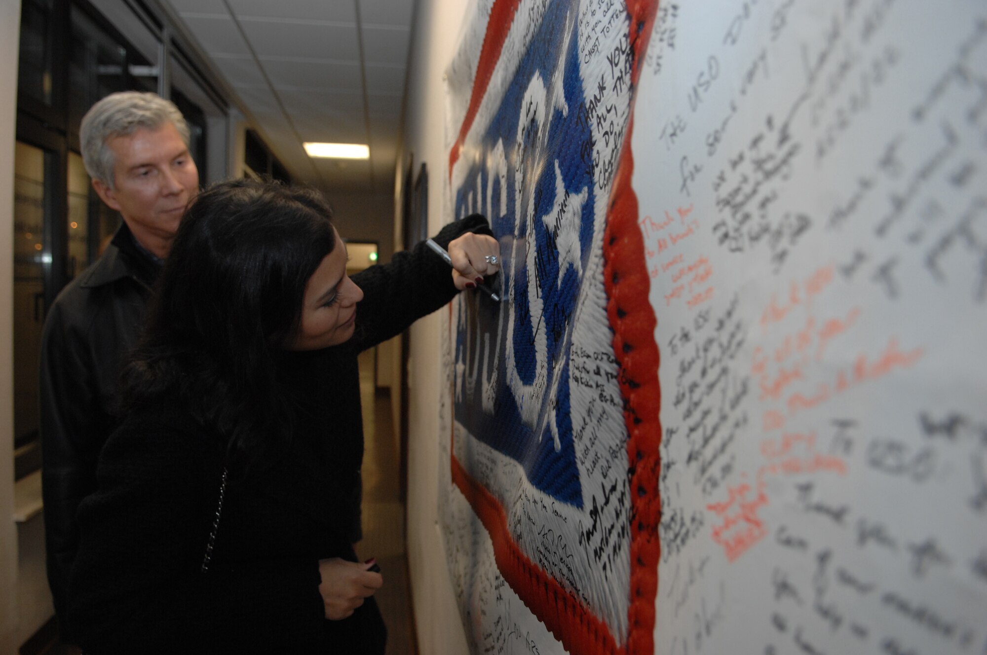 Michael Buffer, professional ring announcer for boxing and wrestling matches, and his wife Christine visit the Contingency Aeromedical Staging Facility, Dec. 15, 2008, Ramstein Air Base, Germany.  The CASF operates all hours of the day and has performed 85,000 patient movements in support of Operations Enduring Freedom and Iraqi Freedom. (U.S. Air Force photo by Senior Airman Amber Bressler)