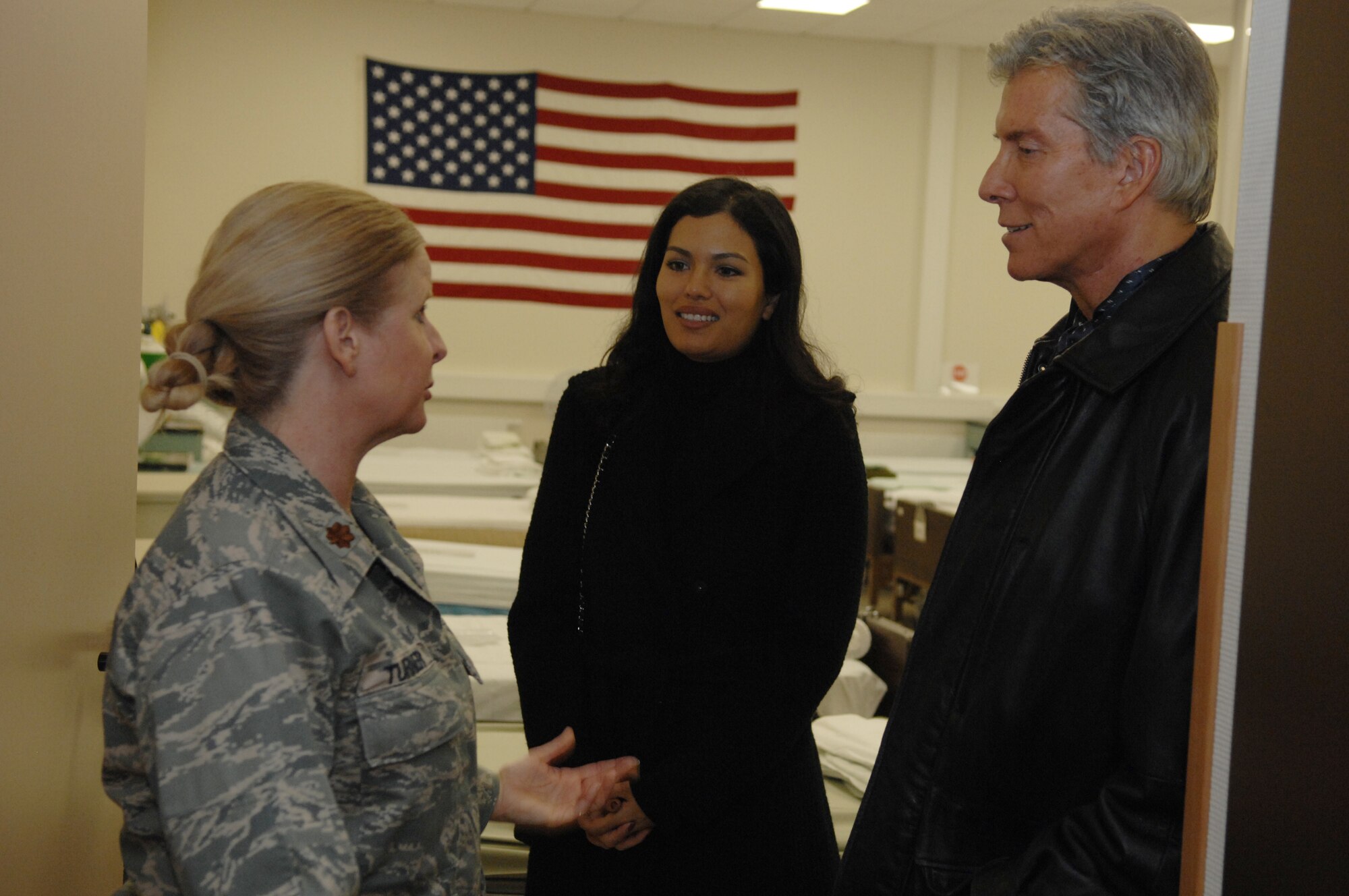 Maj. Laurie Turner (left), Contingency Aeromedical Staging Facility deployed troop commander, Michael Buffer (right), professional ring announcer for boxing and wrestling matches, and his wife Christine, visit the CASF, Dec. 15, 2008, Ramstein Air Base, Germany.  The CASF operates all hours of the day and has performed 85,000 patient movements in support of Operations Enduring Freedom and Iraqi Freedom. (U.S. Air Force photo by Senior Airman Amber Bressler)