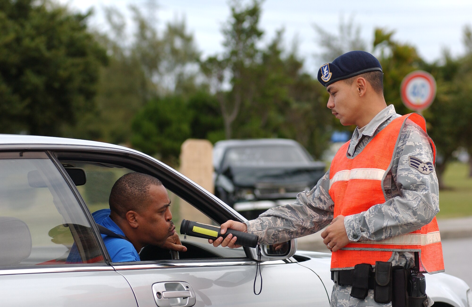 Senior Airman John Camacho, 18th Security Forces Squadron traffic safety unit, makes a traffic checkpoint to conduct a sobriety test using an alcohol detector at different areas on the base December 23, 2008. Kadena law enforcement officials and Okinawa police will exercise increased vigilance during the holidays to prevent drunk driving and keep the roads safe.  (U.S. Air Force photo/Tech. Sgt. Rey Ramon)  