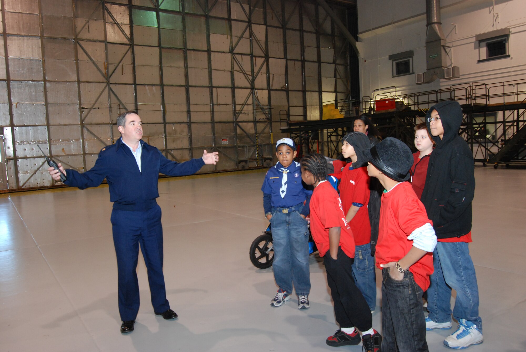 Major James Bayone, 94th Maintenance Group deputy commander and tour guide for Boy Scout Troop 1827 on Dec. 22, presented a mini-tour of the maintenance facilities for t C-130 aircraft at Dobbins Air Reserve Base.  Major Bayone explains the value of having a large hangar space to provide maintenance for the C-130.  (U.S. Air Force photo/Master Sgt. Stan Coleman)