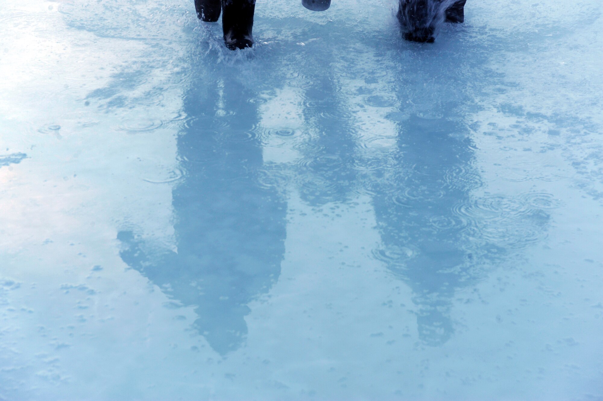 Tech. Sgt. Timothey Broderick and Airman 1st Class Alexandre Leseur carry a water pump in order to flood a portion of the ice bridge which builds up the ice thickness Dec. 23, 2008, Fairbanks, Alaska.  Airmen of the 354th Civil Engineer Squadron range maintenance, Eielson Air Force Base, Alaska are working long hour days over a period of a few weeks to reach the end goal of 60 inches of ice thickness.  (U.S. Air Force photo/Senior Airman Jonathan Snyder)