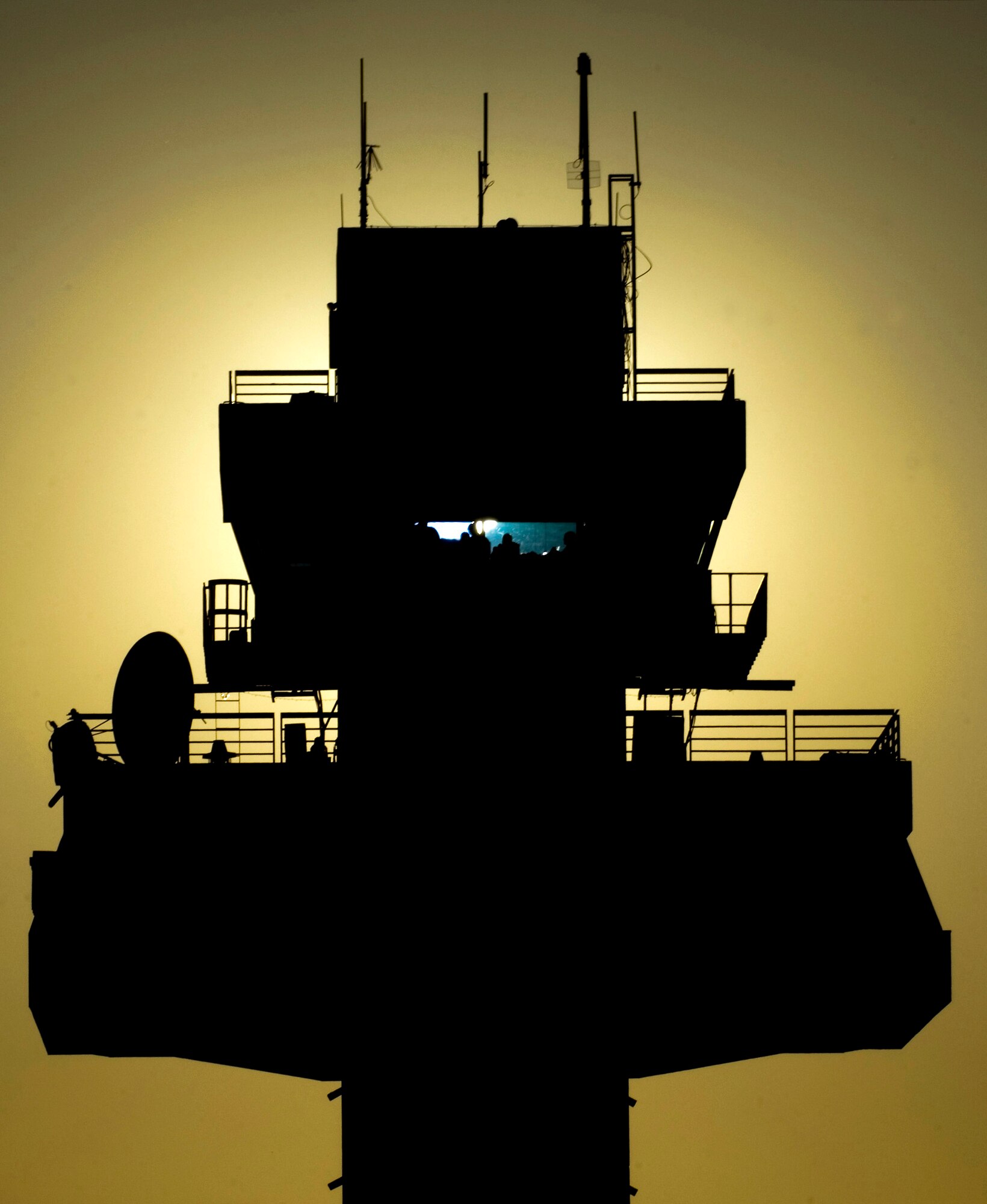 The setting sun silhouettes the air traffic control tower at Joint Base Balad, Iraq, Dec. 18. The 332nd Expeditionary Operations Support Squadron controls aircraft from this tower. The 332nd Air Expeditionary Wing at Balad is the most forward-deployed Air Force wing participating in Operation Iraqi Freedom, and its heritage is tied to the famous 332nd Fighter Group "Tuskegee Airmen" of World War II. (U.S. Air Force photo/Tech. Sgt. Erik Gudmundson)