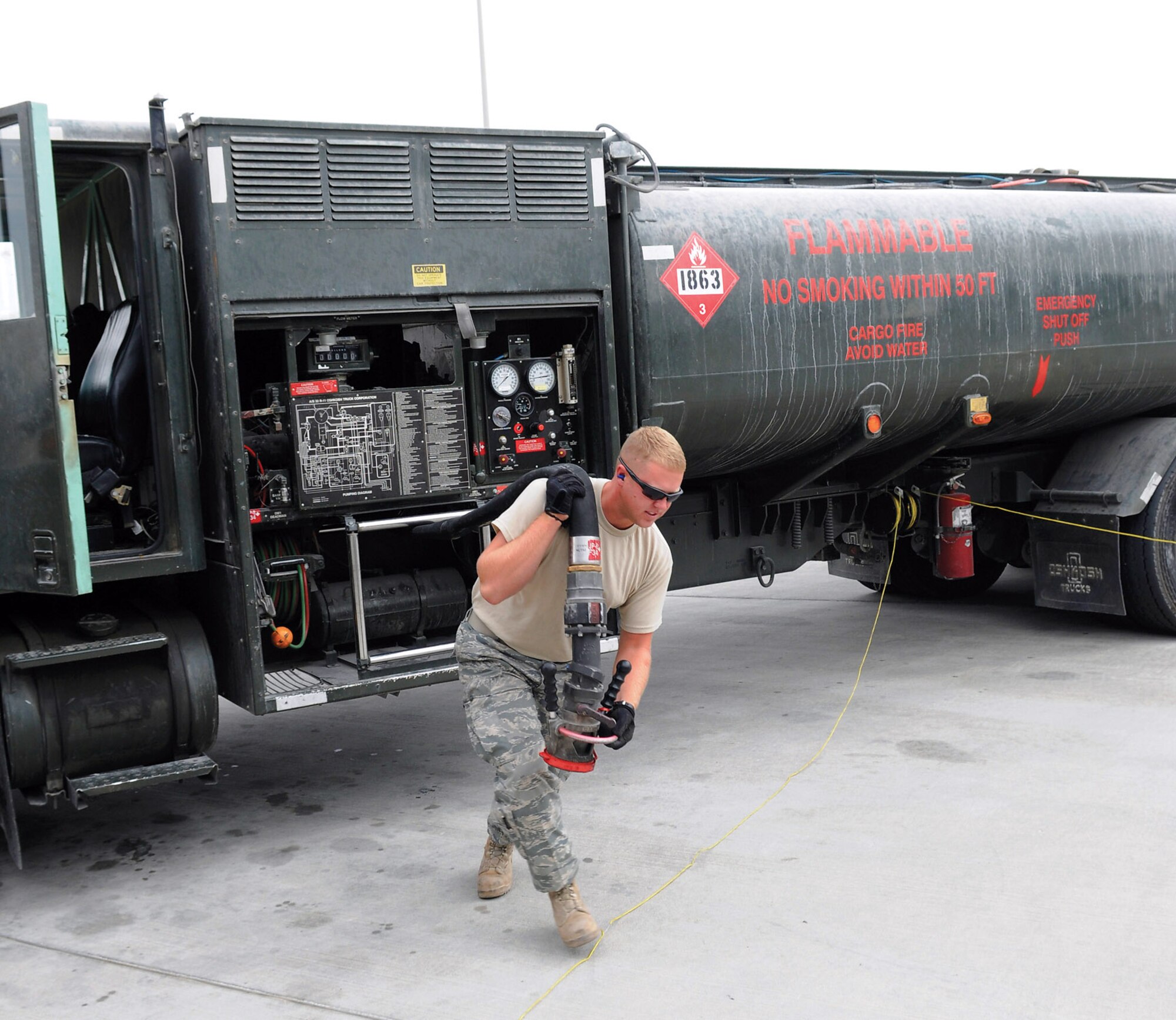 Airman 1st Class Bradley Dean unreels a fuel hose prior to fueling a KC-135 Stratotanker at an air base in Southwest Asia. Airman Dean is a native of Tennessee Colony, Texas, and deployed from Moody Air Force Base, Ga. He is a fuels apprentice assigned to the 379th Expeditionary Logistics Readiness Squadron. (U.S. Air Force photo/Tech. Sgt. Michael Boquette) 
