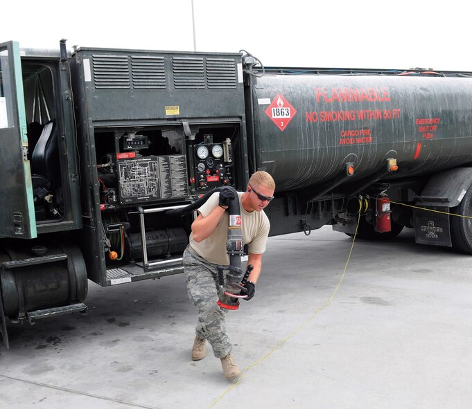 Airman 1st Class Bradley Dean unreels a fuel hose prior to fueling a KC-135 Stratotanker at an air base in Southwest Asia. Airman Dean is a native of Tennessee Colony, Texas, and deployed from Moody Air Force Base, Ga. He is a fuels apprentice assigned to the 379th Expeditionary Logistics Readiness Squadron. (U.S. Air Force photo/Tech. Sgt. Michael Boquette) 