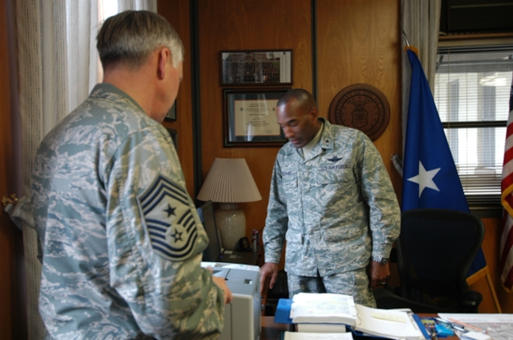 Brig. Gen. A.J. Stewart, Air Force Recruiting Service commander, and Command Chief Master Sgt. Vance Clarke, make a call to congratulate Tech. Sgt. Rob Veuleman on his promotion to Master Sergeant. Sergeant Veuleman was promoted Dec. 23 through the Stripes for Exceptional Performers program. (U.s. Air Force photo/Christa D'Andrea)