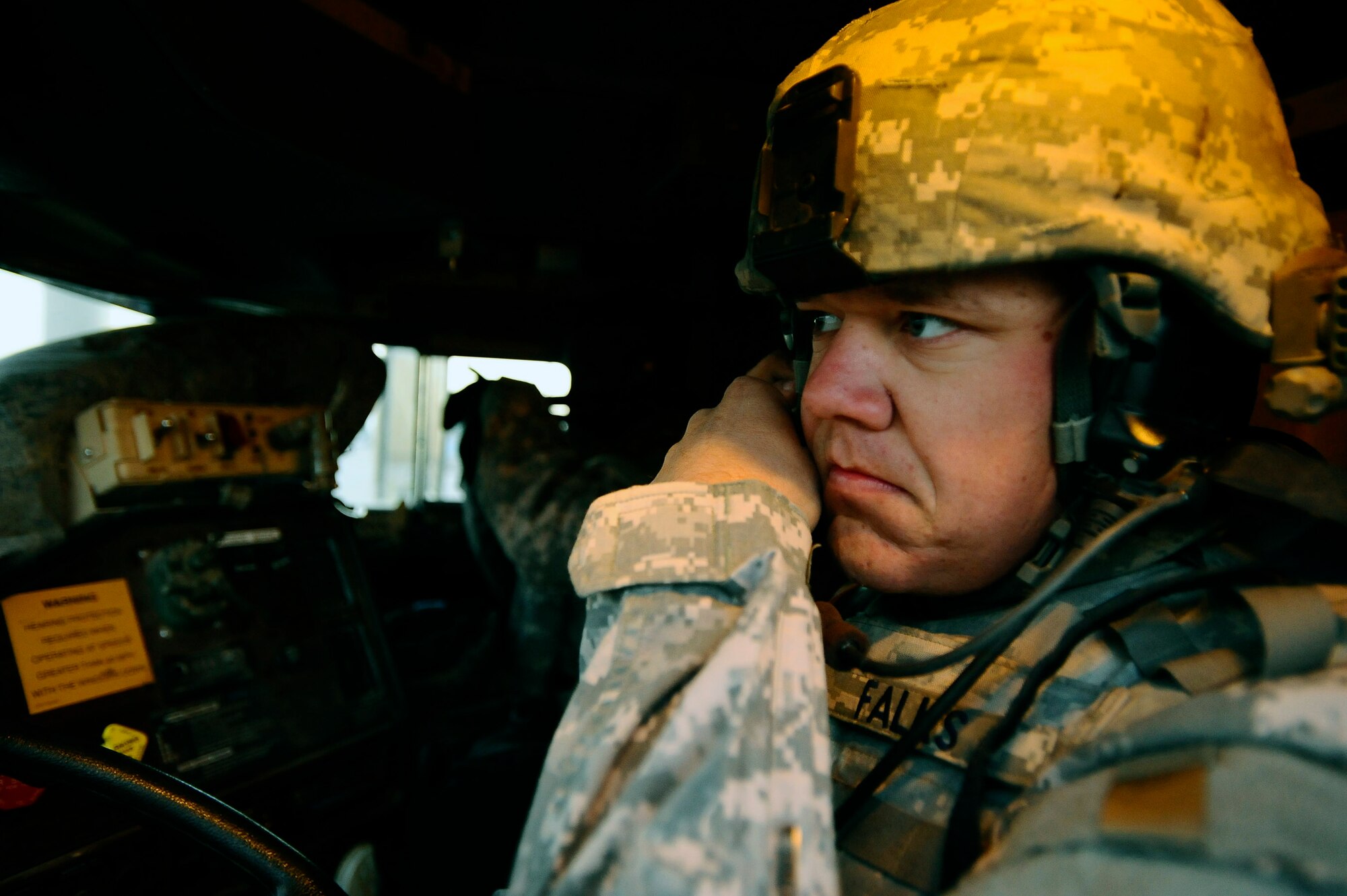 Staff Sgt. Jonathan Falks dons his helmet inside an armored truck Dec. 11 at Joint Base Balad, Iraq. Sergeant Falks and other Airmen with the 732nd Expeditionary Civil Engineer Squadron Det. 6 undertake outside-the-wire construction projects for the Army. Sergeant Falks, a 732nd ECES Det. 6 heavy equipment operator and native of Gonzales, Texas, is deployed from Hickam Air Force Base, Hawaii. (U.S. Air Force photo/Airman 1st Class Jason Epley) 
