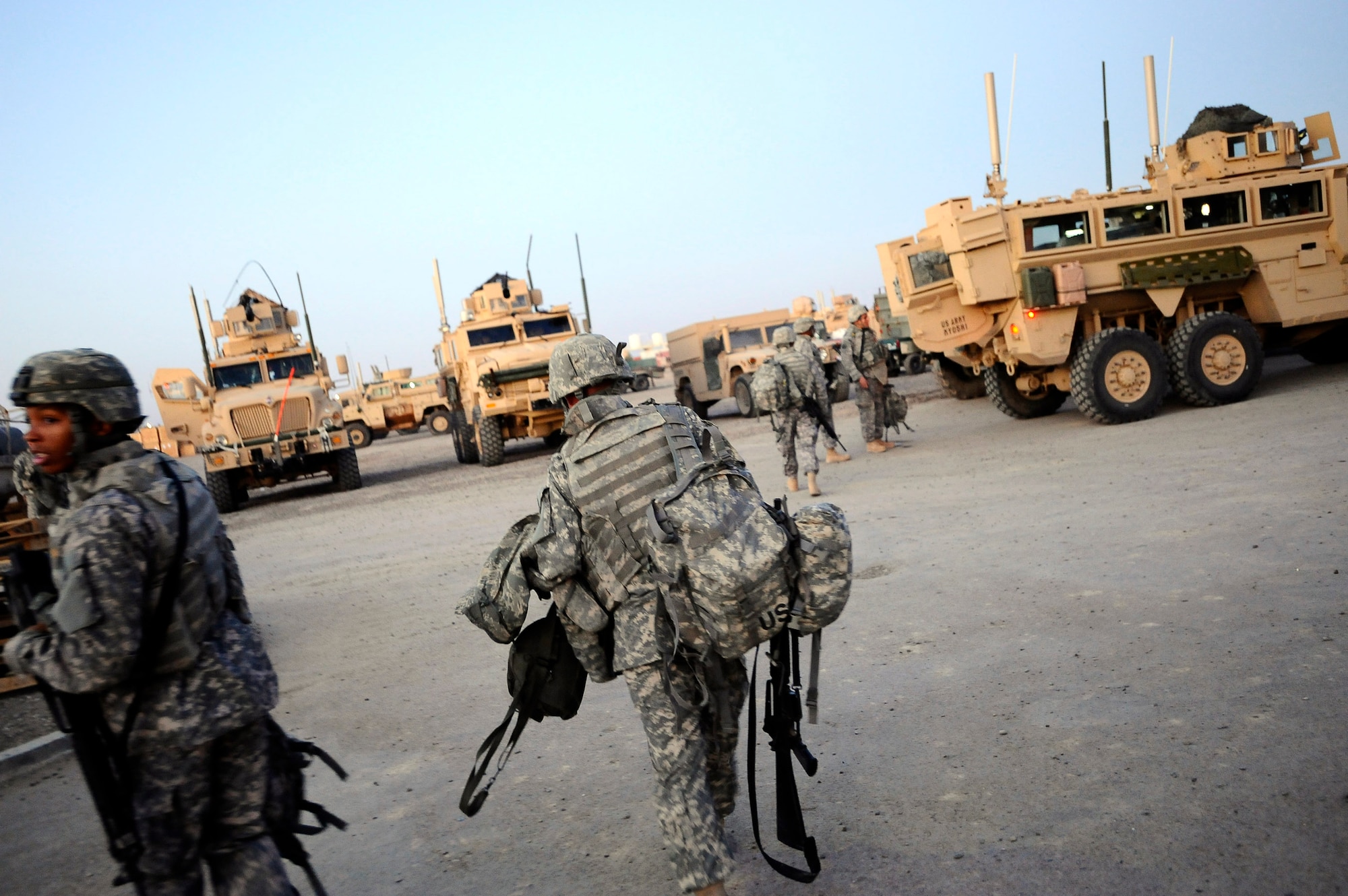 Airmen and Soldiers load into the back of a mine-resistant ambush-protected vehicle Dec. 11 at Joint Base Balad, Iraq. The Airmen, who are assigned to the 732nd Expeditionary Civil Engineer Squadron Det. 6, undertake construction projects for the Army, while the Soldiers provide convoy security. (U.S. Air Force photo/Airman 1st Class Jason Epley) 
