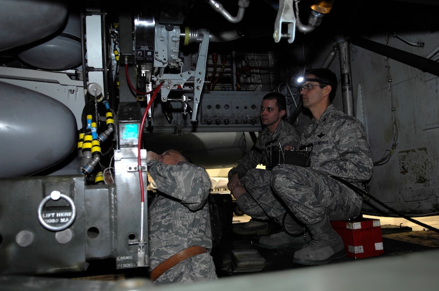 MINOT AIR FORCE BASE, N.D. -- Col. Joel Westa, 5th Bomb Wing commander (left), helps guide Col. Steven Basham, 5th Bomb Wing vice commander (right) as they prepare to attach an air-launch cruise missile to the bomb bay of a B-52H Stratofortress here Dec. 23. The loading event gave the commanders a chance to see what obstacles missile loaders must overcome to make the mission a success. Several other 5th BW commanders also participated in the missile loading. (U.S. Air Force photo by Senior Airman Joe Rivera)