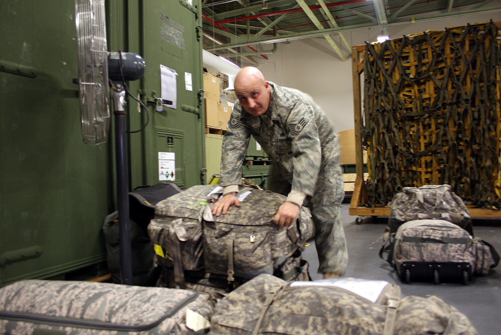 WRIGHT-PATTERSON AFB, Ohio - Tech. Sgt. Khristopher Powell, 445th Security Forces Squadron, prepares his bag Dec. 20, 2008, before leaving for a six month deployment to Southwest Asia.  The 445th Security Forces Squadron had 18 members deploy in December. (Air Force photo/Maj. Cynthia Harris) 