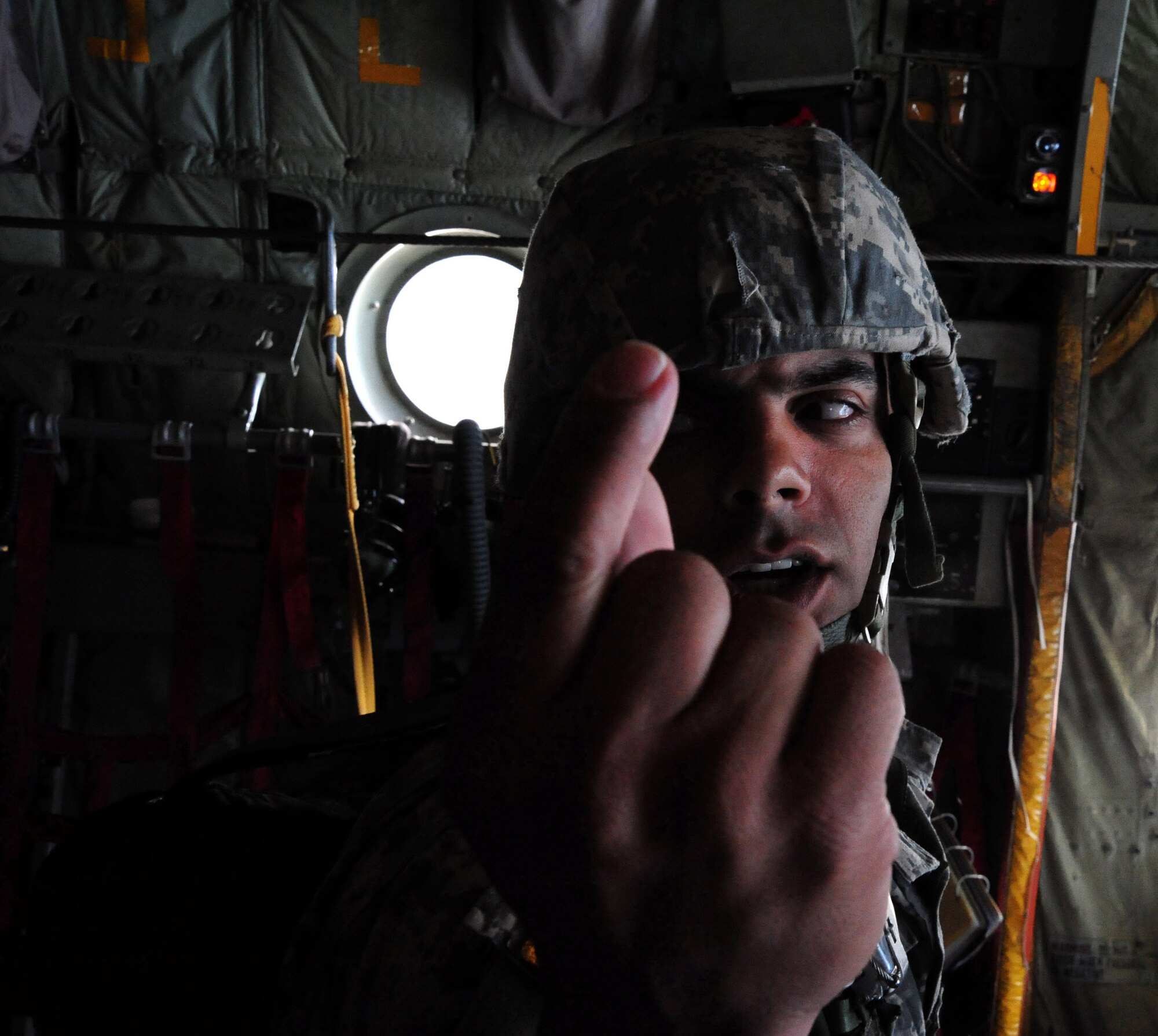 1st Lt. Samuel Flecha, 20th Special Forces parajumper, signals 30 seconds out from the drop zone during "Operation Toy Drop" here Dec. 18. For this event, 196 Jumpers from SOCCENT, SOCOM, JSCE, CENTCOM, SOCSOUTH and the 20th Special Forces Group donated toys to benefit the USMC Reserve Center's Toys for Tots drive. "Operation Toy Drop” jumpers had to donate toys in order to manifest for this jump. During the 59 years of the United States Marine Corps Reserve Toys for Tots Program, Marines have distributed more than 370 million toys to more than 173 million needy children. This charitable endeavor has made U.S. Marines the unchallenged leaders in looking after less fortunate children at Christmas. Over its 16 year life span, the Marine Toys for Tots Foundation has supplemented local toy collections with more than 70.2 million toys valued at more than $387 million and provided promotion and support materials valued at over $4.7 million. (U.S. Air Force photo by Staff Sgt. Ronnie Hill) 