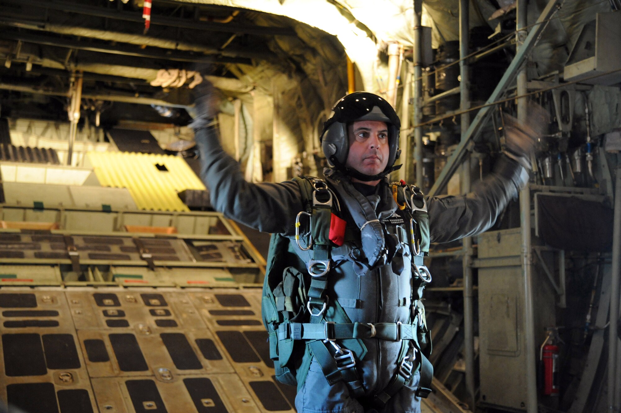 Lt. Col. Dennis Harrison, USSOCOM jumpmaster, directs parajumpers for a free fall jump from a C-130 at 10,000 feet during "Operation Toy Drop" here Dec.18.  For this event, 196 Jumpers from SOCCENT, SOCOM, JSCE, CENTCOM, SOCSOUTH and the 20th Special Forces Group donated toys to benefit the USMC Reserve Center's Toys for Tots drive. "Operation Toy Drop” jumpers had to donate toys in order to manifest for this jump. During the 59 years of the United States Marine Corps Reserve Toys for Tots Program, Marines have distributed more than 370 million toys to more than 173 million needy children. This charitable endeavor has made U.S. Marines the unchallenged leaders in looking after less fortunate children at Christmas. Over its 16 year life span, the Marine Toys for Tots Foundation has supplemented local toy collections with more than 70.2 million toys valued at more than $387 million and provided promotion and support materials valued at over $4.7 million.(U.S. Air Force photo by Staff Sgt. Ronnie Hill) 