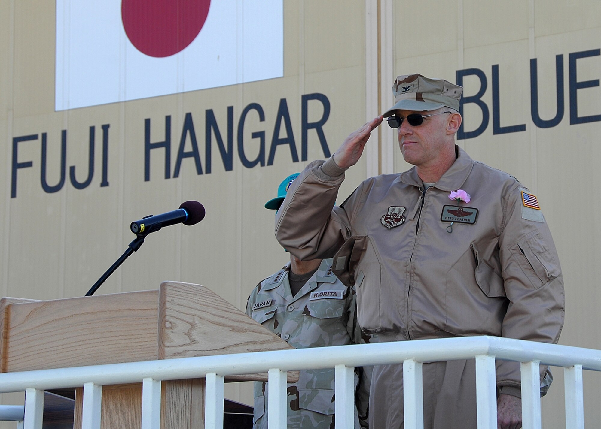 Col. Paul "Otto" Feather, 386th Air Expeditionary Wing vice commander, renders a final salute to the Japanese Air Self Defense Forces during their mission closing ceremony on Dec. 17 at an air base in Southwest Asia. The JASDF members are departing the Iraq Reconstruction Support Airlift Wing after serving alongside U.S. and coalition forces for nearly five years. (U.S. Air Force photo/Tech. Sgt. Raheem Moore)