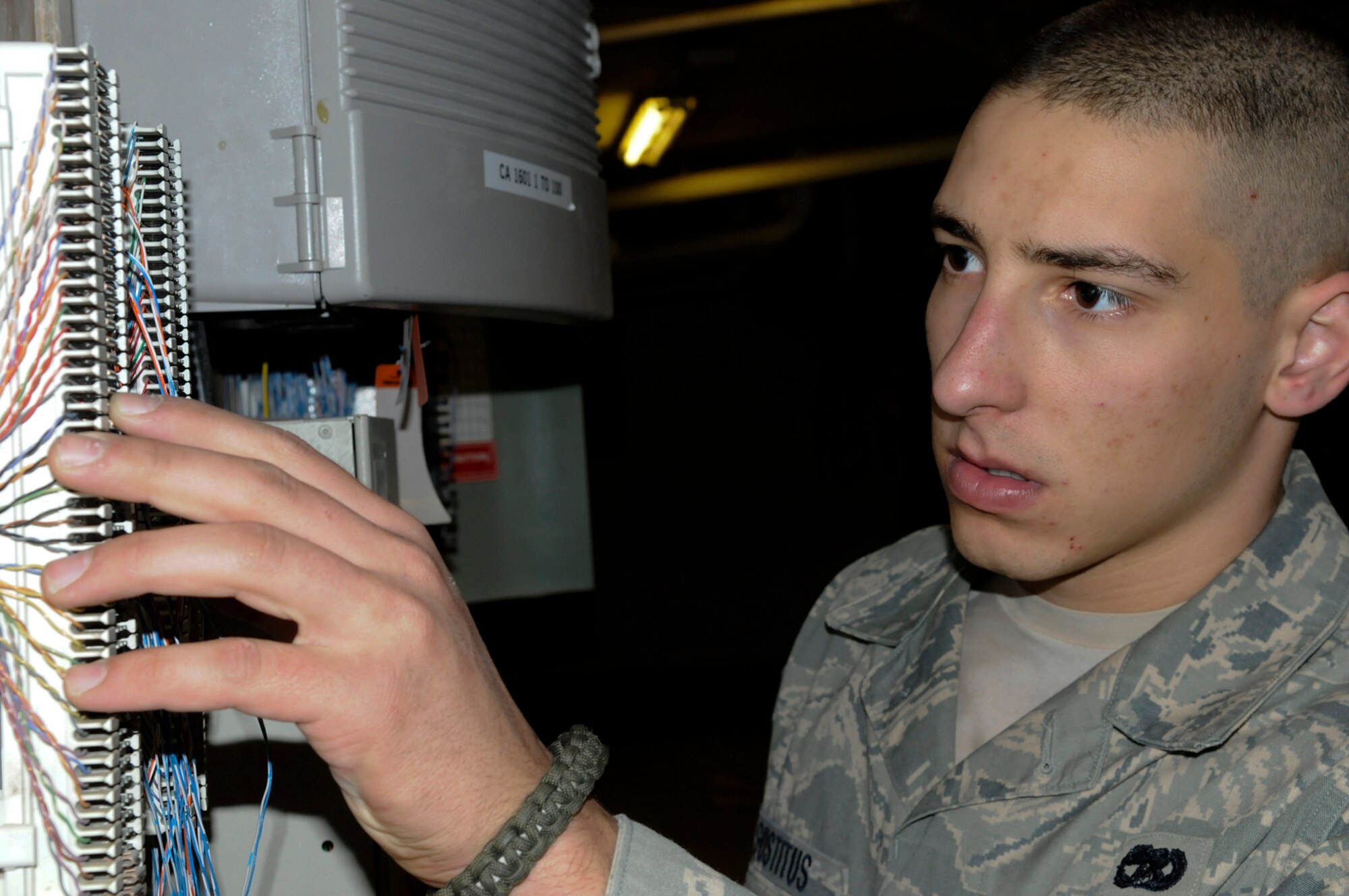 Senior Airman Joseph Gustitus traces a telephone connection ensuring the line is properly connected here Wednesday. The communications squadron provides command and control, communications and information services for U.S. and Coalition forces at the 379th Air Expeditionary Wing.  Airman Gustitus is a native of Nashua, N.H., and is deployed from Pease Air National Guard Base, N.H., in Support of Operations Iraqi and Enduring Freedom and Joint Task Force-Horn of Africa.  (U.S. Air Force photo by Tech. Sgt. Michael Boquette)