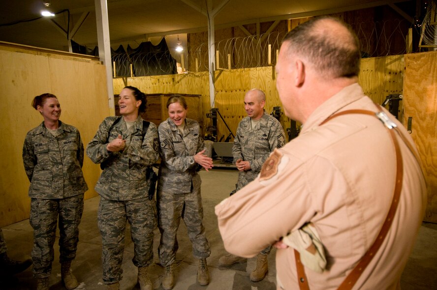 Lt. Gen. Gary North, U.S. Air Forces Central commander, looks on as Senior Master Sgt. Sherry Jensen, 455th Expeditionary Maintenance Group first sergeant, and Staff Sgt. Rhyannon Linnabary, 455th EMXG, sing "Rudolph the Red-Nose Reindeer" at Bagram Air Field, Afghanistan, Christmas Eve, Dec. 24. General North was told that Sergeant Linnabary had a great singing voice, but it wasn't until Sergeant Jensen started her off that she overcame her stage-fright. (U.S. Air Force photo by Staff Sgt. Samuel Morse)(Released)
