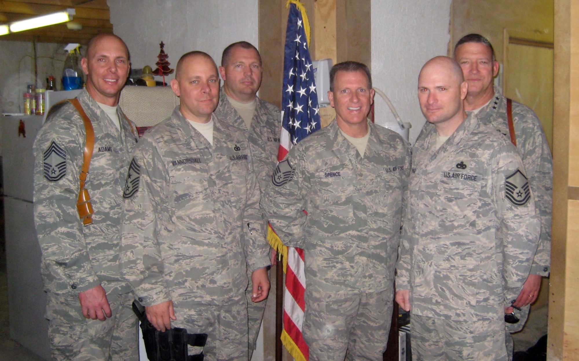 KANDAHAR AIR FIELD, Afghanistan – Master Sgt. Frank Spence and fellow Airmen take a moment to commemorate his Christmas Day promotion with a photo. Sergeant Spence was promoted by Lt. Gen.  Gary North (right), 9th Air Force and U.S. Air Forces Central, Shaw Air Force Base, S.C. Sergeant Spence is a logistics planner deployed here from Atlantic City Guard Base, N.J. (Courtesy photo)