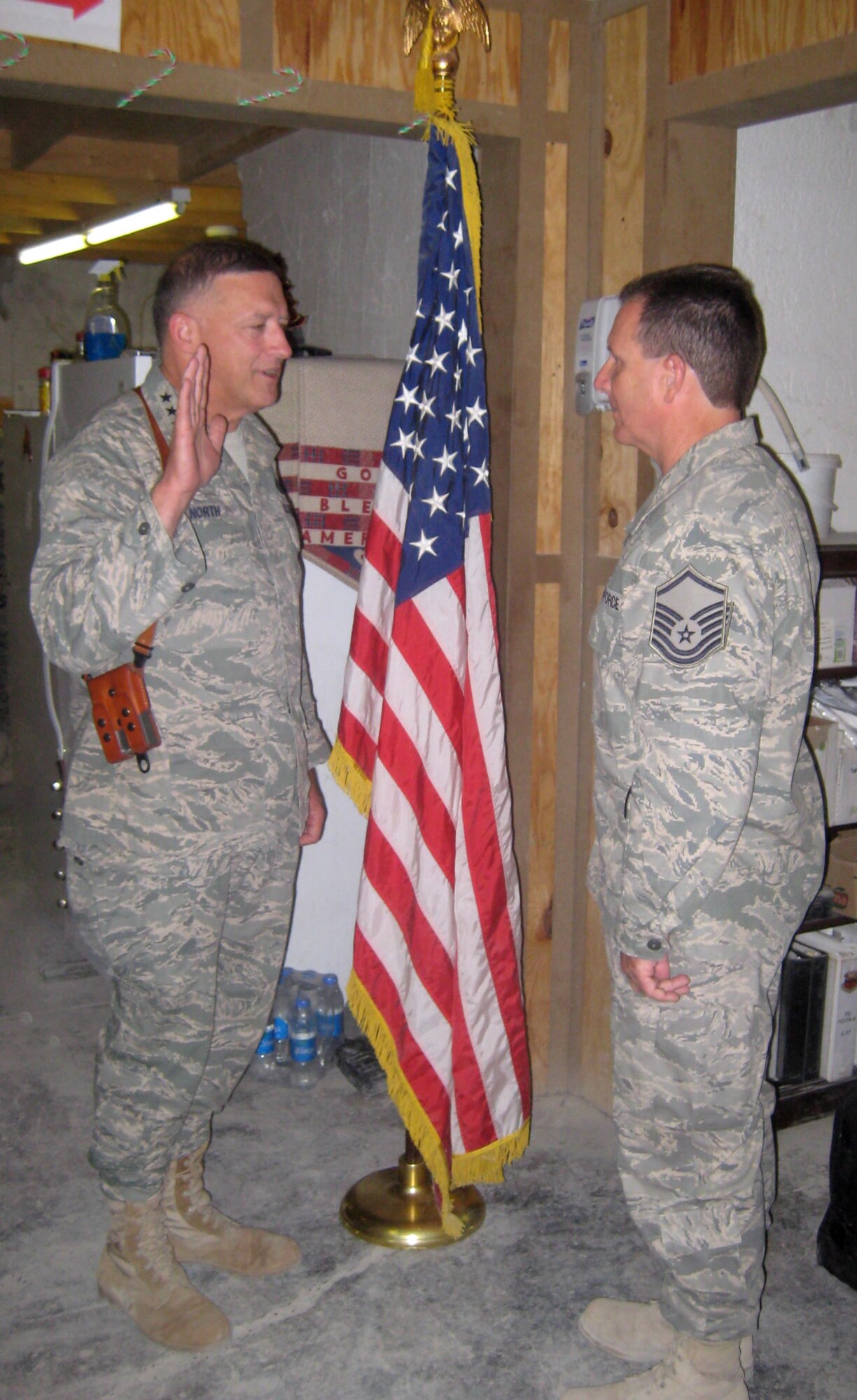 KANDAHAR AIR FIELD, Afghanistan -- Master Sgt. Frank Spence affirms the oath of office administered by Lt. Gen.  Gary North, 9th Air Force and U.S. Air Forces Central, Shaw Air Force Base, S.C., on Christmas Day. Sergeant Spence is a logistics planner deployed here from Atlantic City Guard Base, N.J. (Courtesy photo)