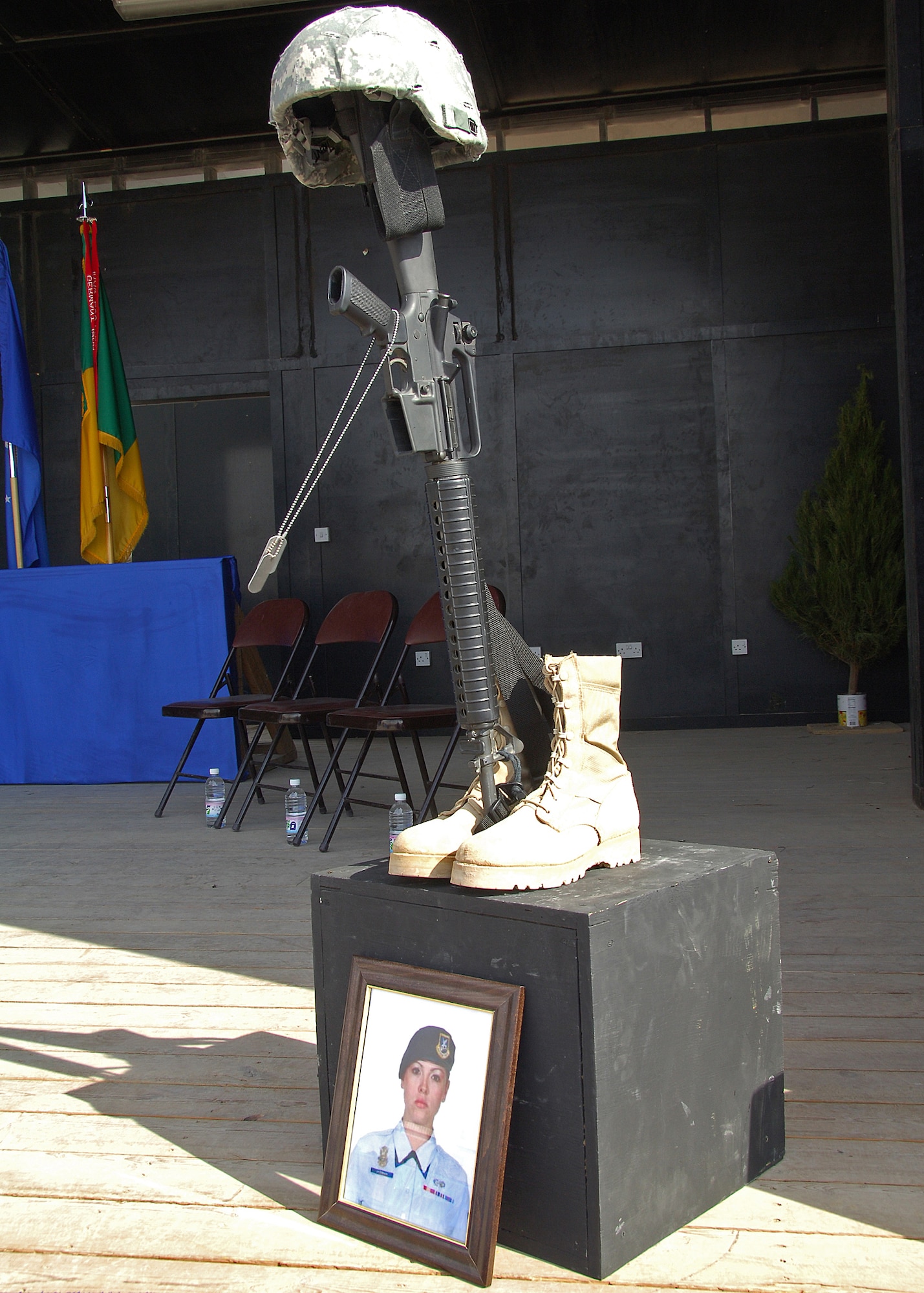 CAMP BUCCA, IRAQ -- A memorial dedicated to Airman 1st Class Elizabeth Jacobson is displayed during the inactivation ceremony of the 586th Expeditionary Security Forces Squadron on Dec. 22. During its tenure, the 586th ESFS provided detainee operations and forward operating base defense, and conducted area security operations while providing convoy security for almost four years. The different mission sets of the 586th ESFS will now be handled by the 887th ESFS and Ugandan military members. Airman Jacobson was killed in action when her vehicle was struck by an improvised explosive device while providing security for a supply convoy. (U.S. Air Force photo/Tech. Sgt. Raheem Moore)