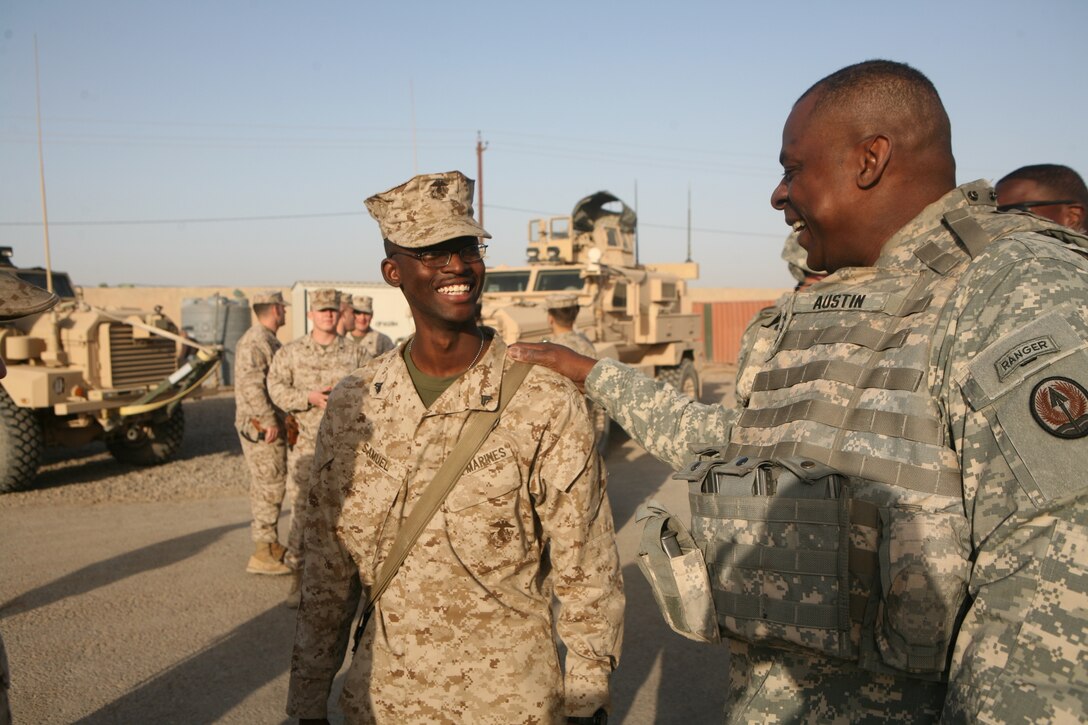 Lt. Gen. Lloyd J. Austin III, commanding general, Multi-National Corps Iraq, speaks with Cpl. Michael Samuel, an administration clerk from Tuscaloosa, Ala., with Headquarters Company, 1st Battalion, 4th Marines, Regimental Combat Team 1, during a holiday visit to Camp Baharia in Fallujah, Iraq, Dec. 25.