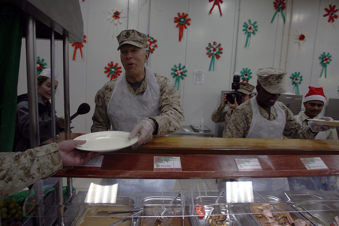 General James T. Conway, Commandant of the Marine Corps, serves dinner at a dining facility here Dec. 25. Conway and Sergeant Major Carlton W. Kent, Sergeant Major of the Marine Corps, talked to Marines about the growth of the Corps and the Corps? anticipated shift to Afghanistan during a ?town hall? meeting earlier in the night.