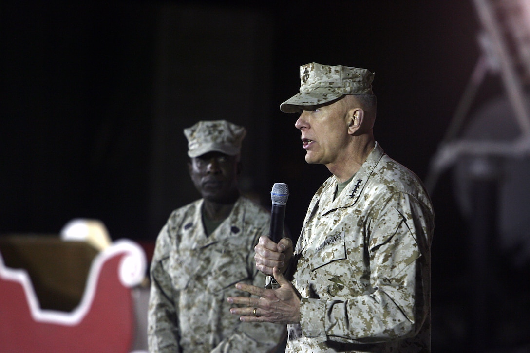 General James T. Conway, Commandant of the Marine Corps, speaks to Marines, Sailors and Soldiers during a ?town hall? meeting here Dec. 25. Conway and Sergeant Major Carlton W. Kent, Sergeant Major of the Marine Corps, talked about the growth of the Corps and the Corps? anticipated shift to Afghanistan.