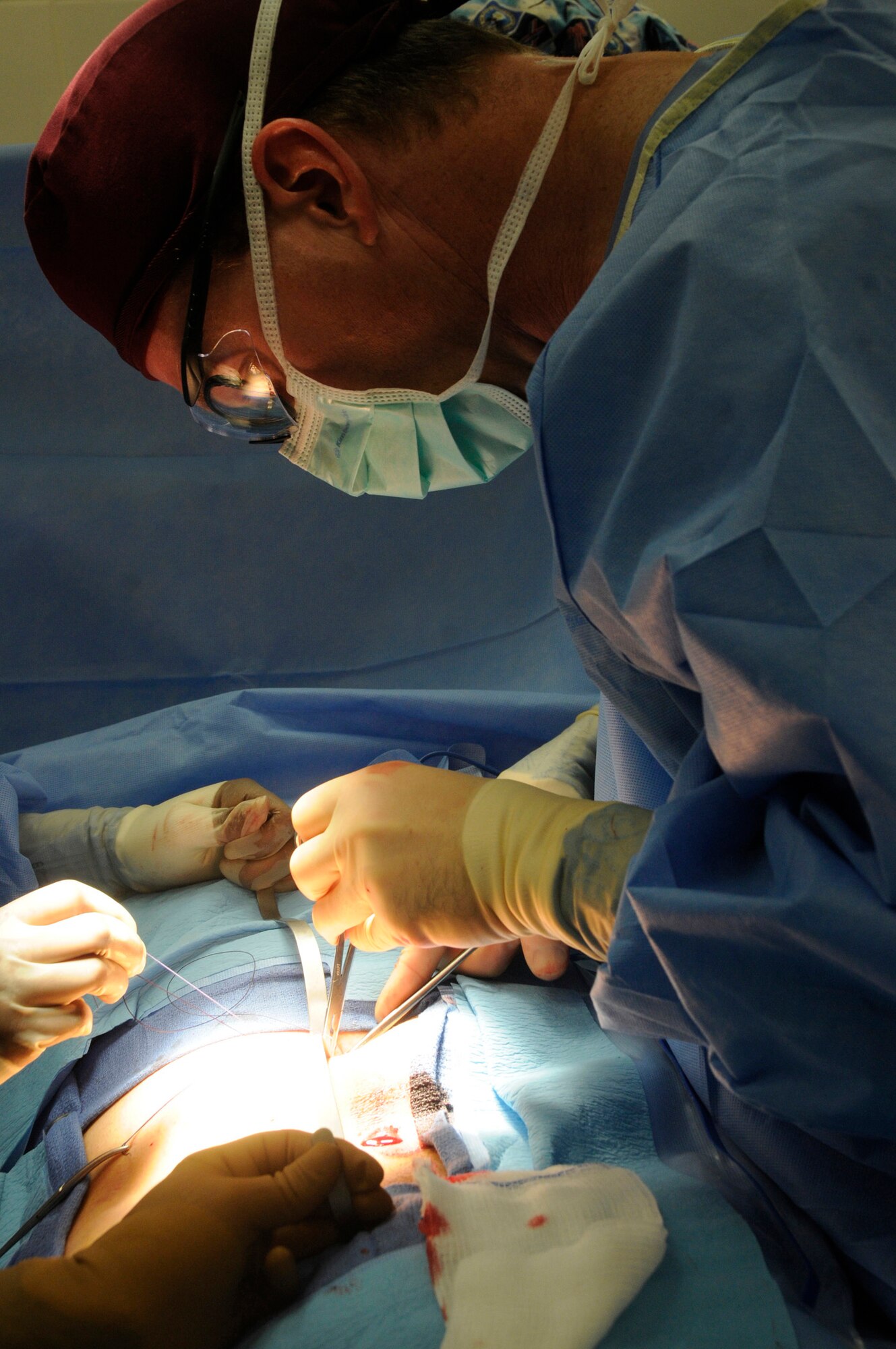 Maj. Craig Kolasch, general surgeon assigned to the 379th Expeditionary Medical Group, stitches up an incision after completing a laparoscopic hernia repair Dec. 23, 2008, at an undisclosed air base in Southwest Asia. Many of the surgeries performed here are hernia repairs. Major Kolasch, a native of Great Falls, Va., is deployed from Keesler Air Force Base, Miss., in support of Operations Iraqi and Enduring Freedom and Joint Task Force-Horn of Africa. (U.S. Air Force photo by Staff Sgt. Darnell T. Cannady/Released)