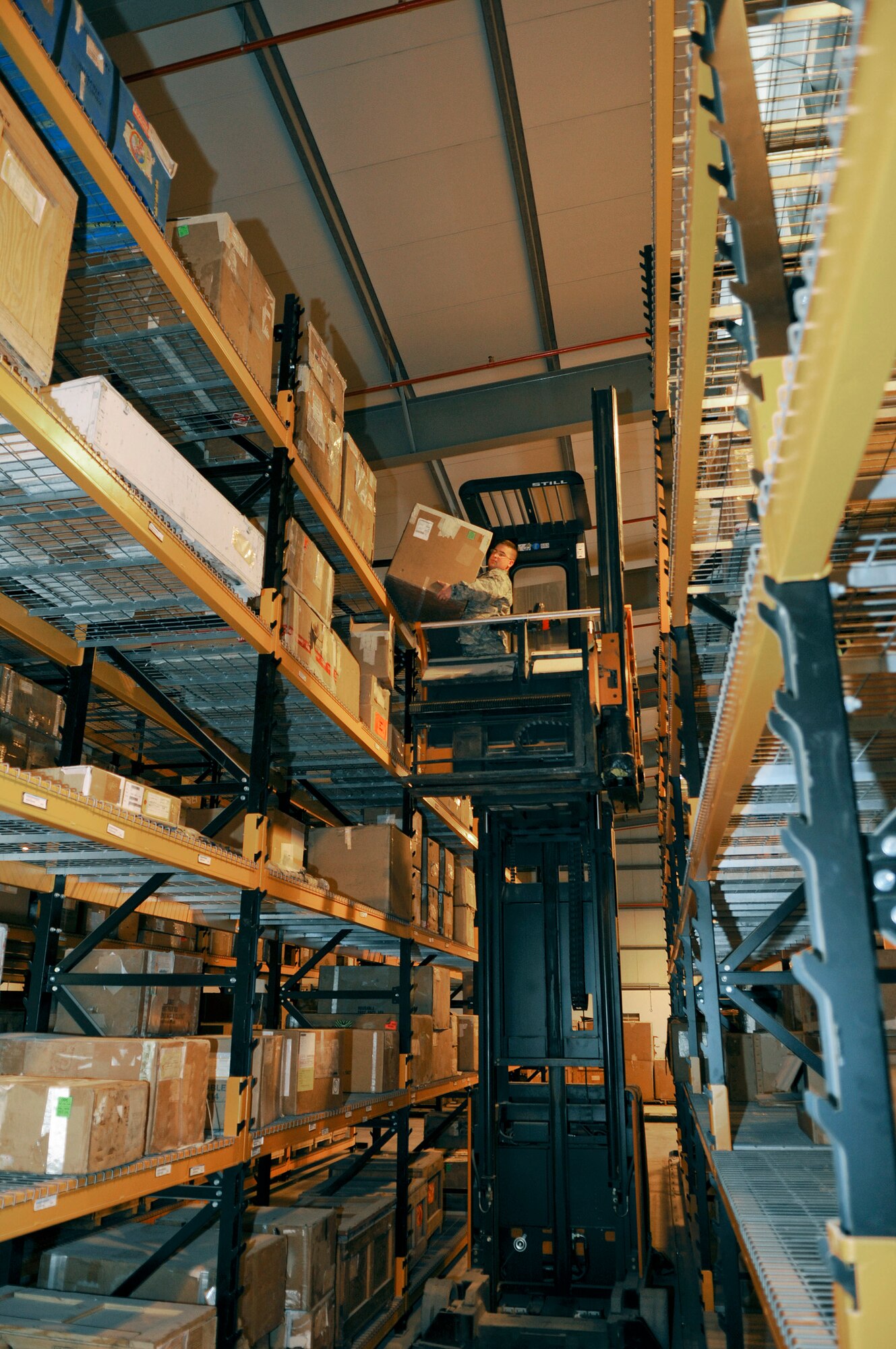 Senior Airman Joshua Pearl, a supply journeyman assigned to the 379th Expeditionary Logistics Readiness Squadron, uses material handling equipment to reach the uppermost shelf to store parts, Dec. 22, 2008, at an undisclosed air base in Southwest Asia.  The supply team runs the consolidated aircraft parts storage facility, a collocated facility where all maintenance teams can go to pick up items to fix their specific aircraft.  Airman Pearl is a native of Glen Carbon Ill., and deployed from Mountain Home Air Force Base, Idaho, in support of Operations Iraqi and Enduring Freedom and Joint Task Force-Horn of Africa.  (U.S. Air Force photo by Tech. Sgt. Michael Boquette/Released)