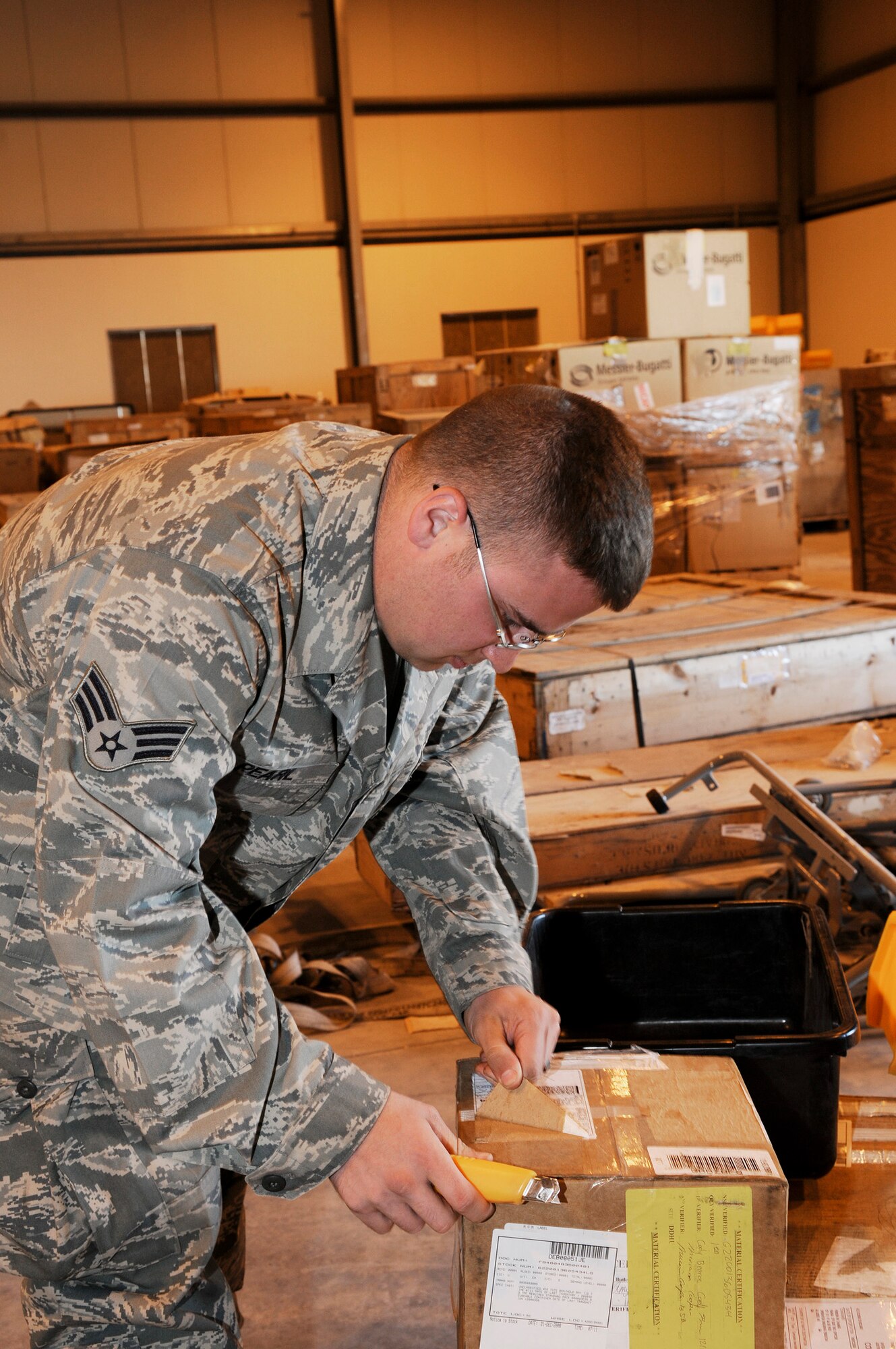 Senior Airman Joshua Pearl, a supply journeyman assigned to the 379th Expeditionary Logistics Readiness Squadron, removes all labels from inbound cargo, Dec. 22, 2008, at an undisclosed air base in Southwest Asia.  The supply team runs the consolidated aircraft parts storage facility, a collocated facility where all maintenance teams can go to pick up the items to fix their specific aircraft.  Airman Pearl is a native of Glen Carbon Ill., and deployed from Mountain Home Air Force Base, Idaho, in support of Operations Iraqi and Enduring Freedom and Joint Task Force-Horn of Africa.  (U.S. Air Force photo by Tech. Sgt. Michael Boquette/Released)